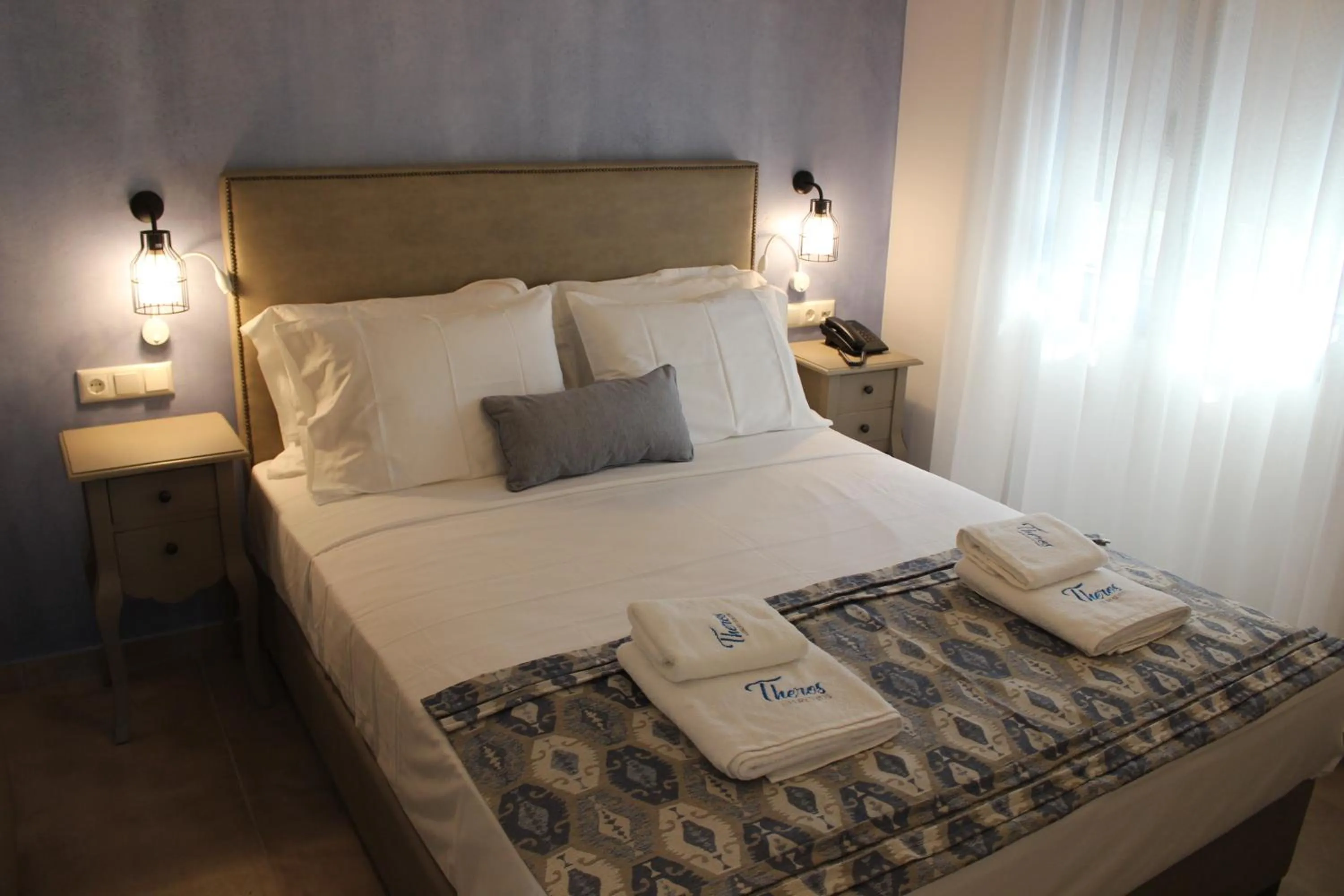 Bed in Theros Villas & Suites