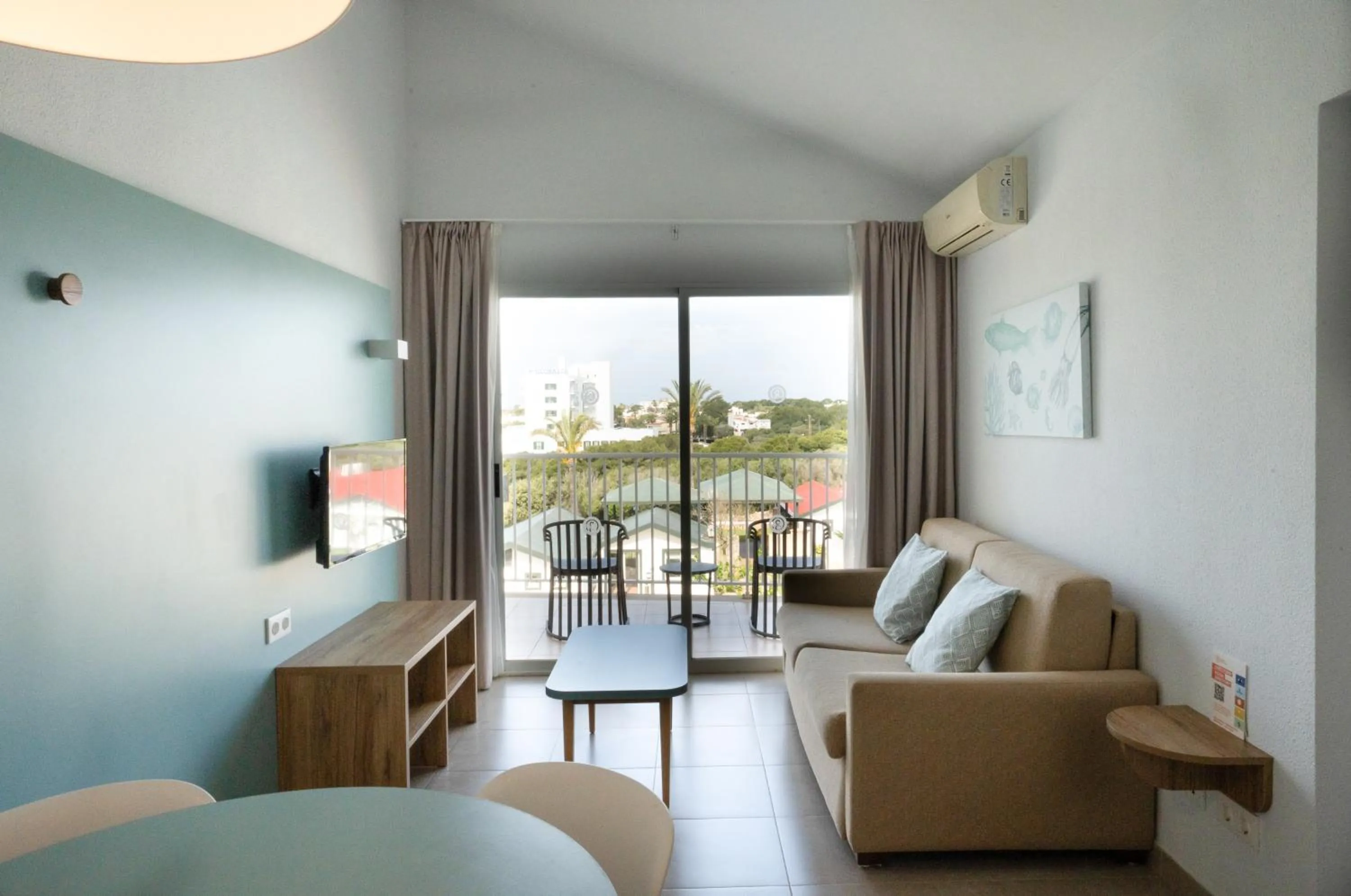 Living room, Bed in Pierre & Vacances Menorca Cala Blanes