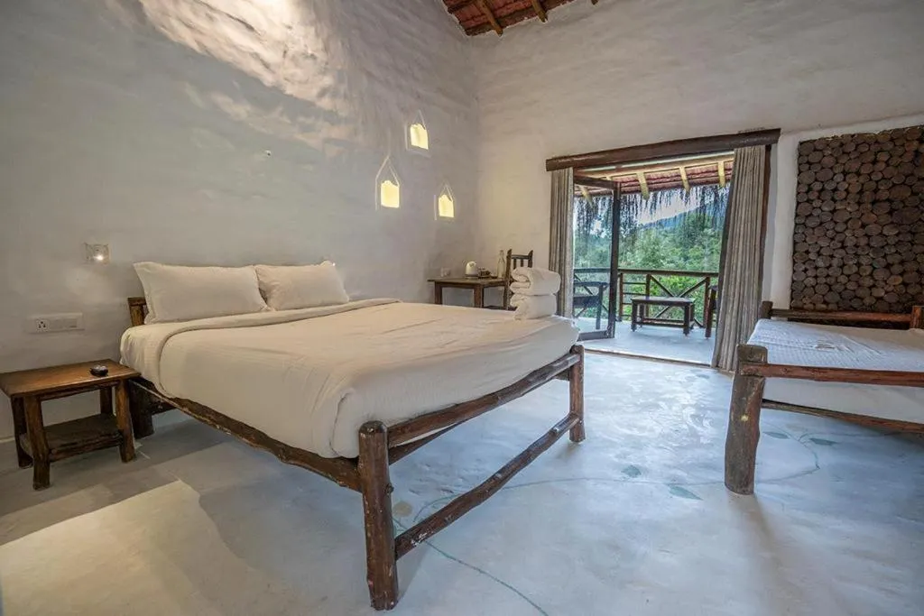 Bed in Deshadan Eco Valley Resort - An Eco friendly Mud House