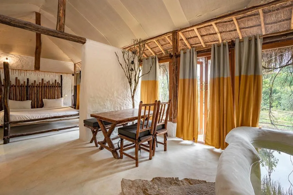 Living room, Bed in Deshadan Eco Valley Resort - An Eco friendly Mud House