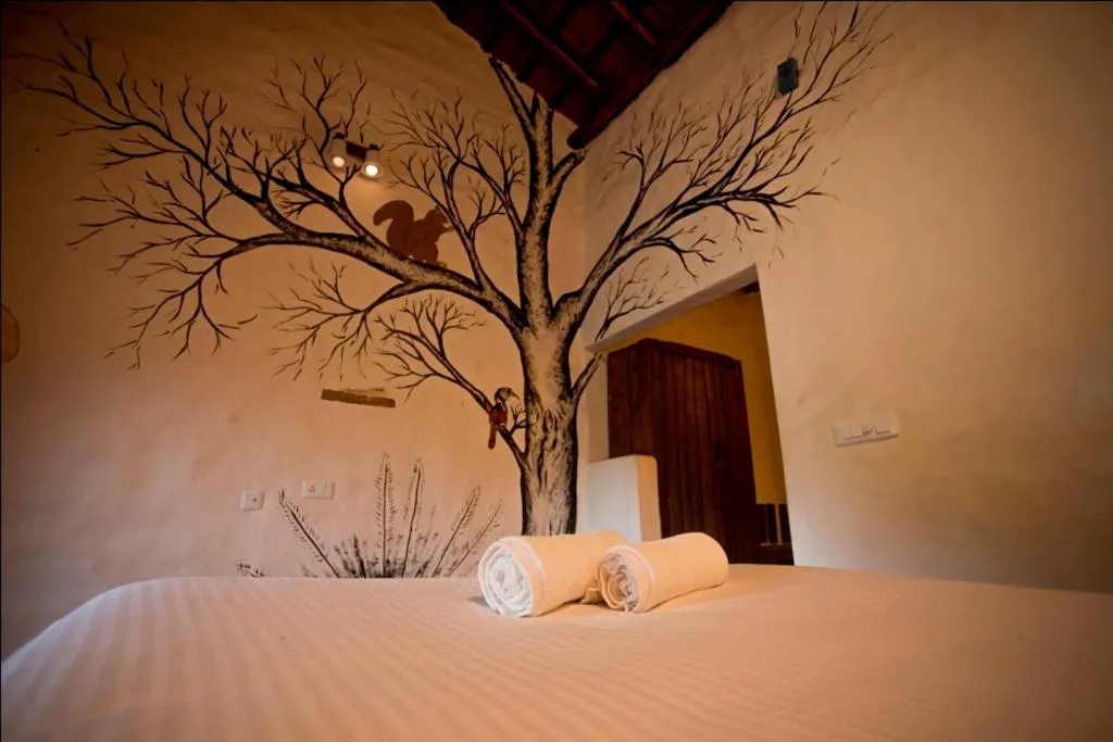 Bed in Deshadan Eco Valley Resort - An Eco friendly Mud House