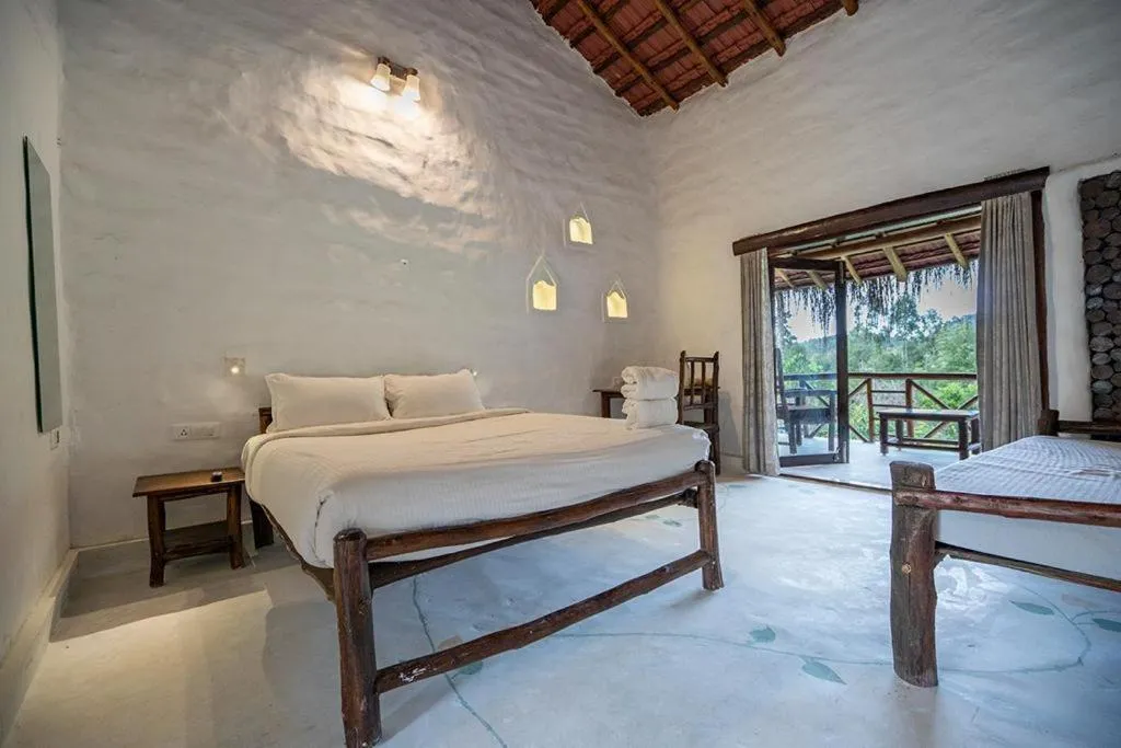 Bed in Deshadan Eco Valley Resort - An Eco friendly Mud House