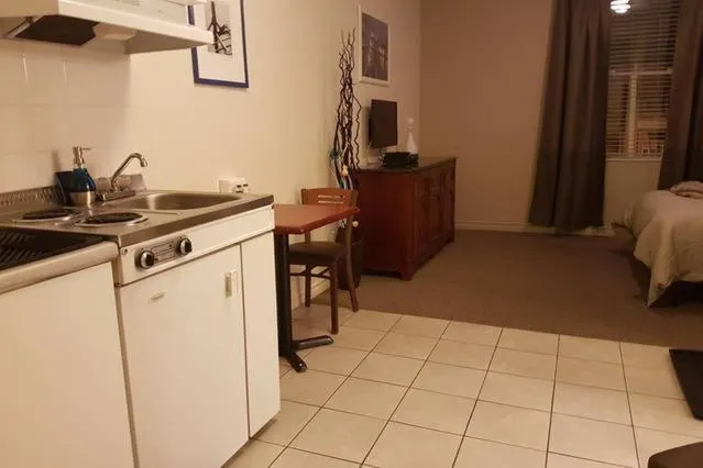 Kitchen or kitchenette, Bed in Cozy Little Studio #16 by Amazing Property Rentals