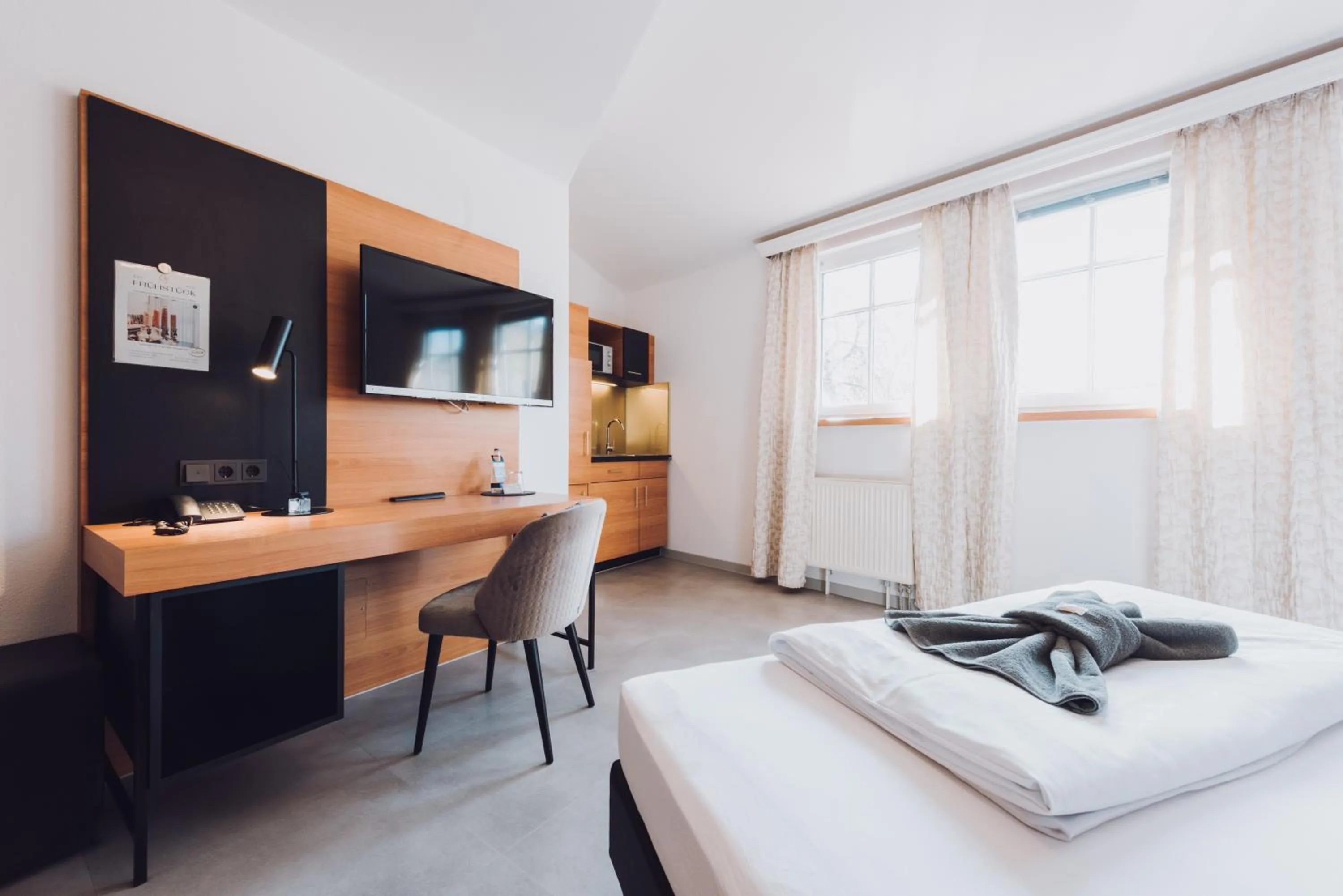 Kitchen or kitchenette, Bed in Ambienthotel Tassilo