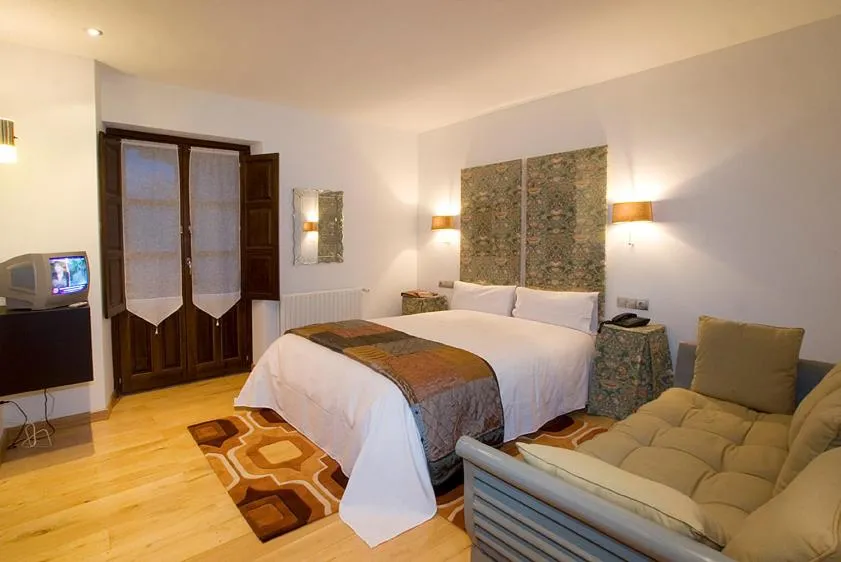 Bed in Hotel y apartamentos rurales L'Anceo