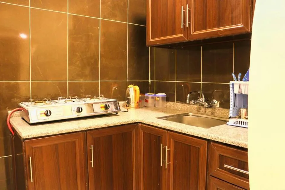 Kitchen or kitchenette in Al Riyati Hotel Apartments
