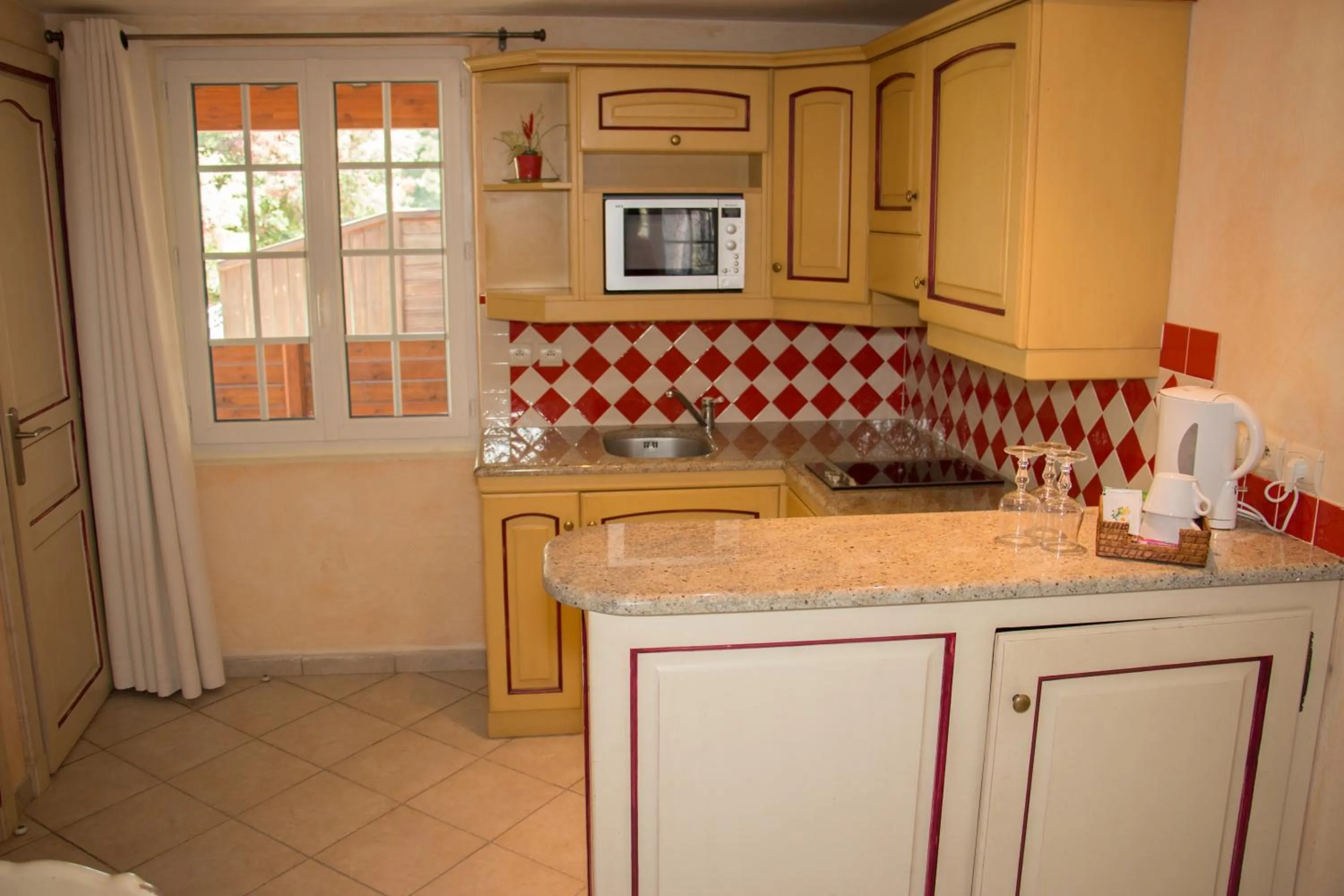 Kitchen or kitchenette in Hôtel & Spa La Villa