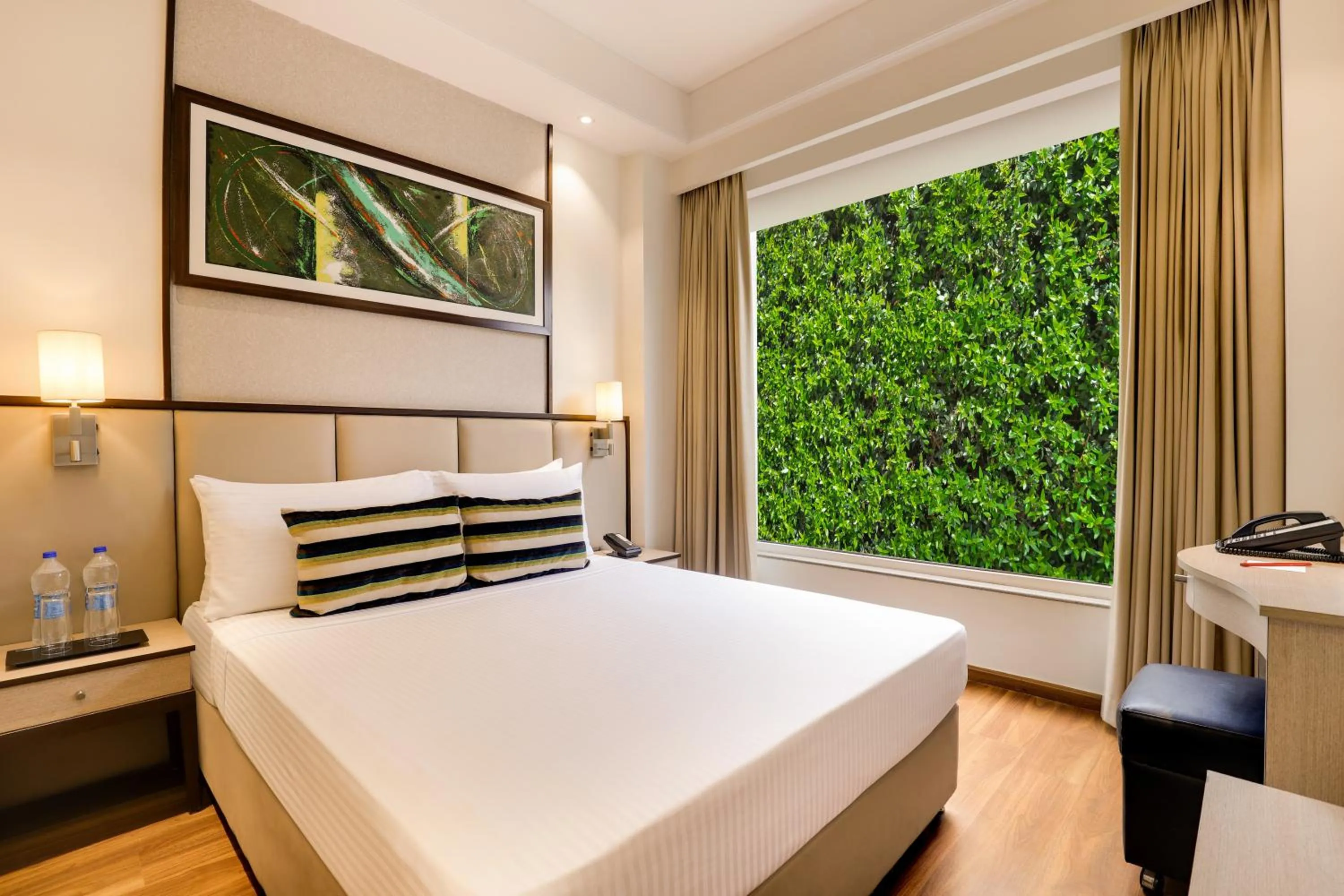Bed in Sandal Suites by Lemon Tree Hotels