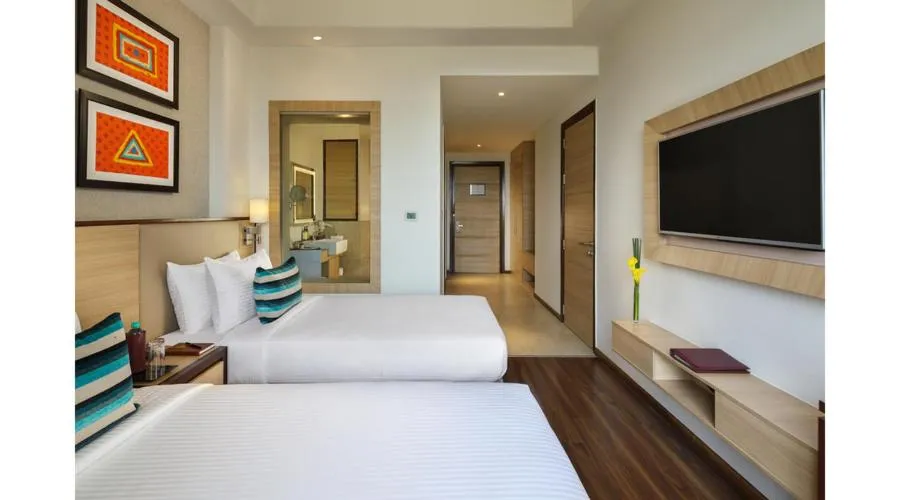 Bed in Sandal Suites by Lemon Tree Hotels