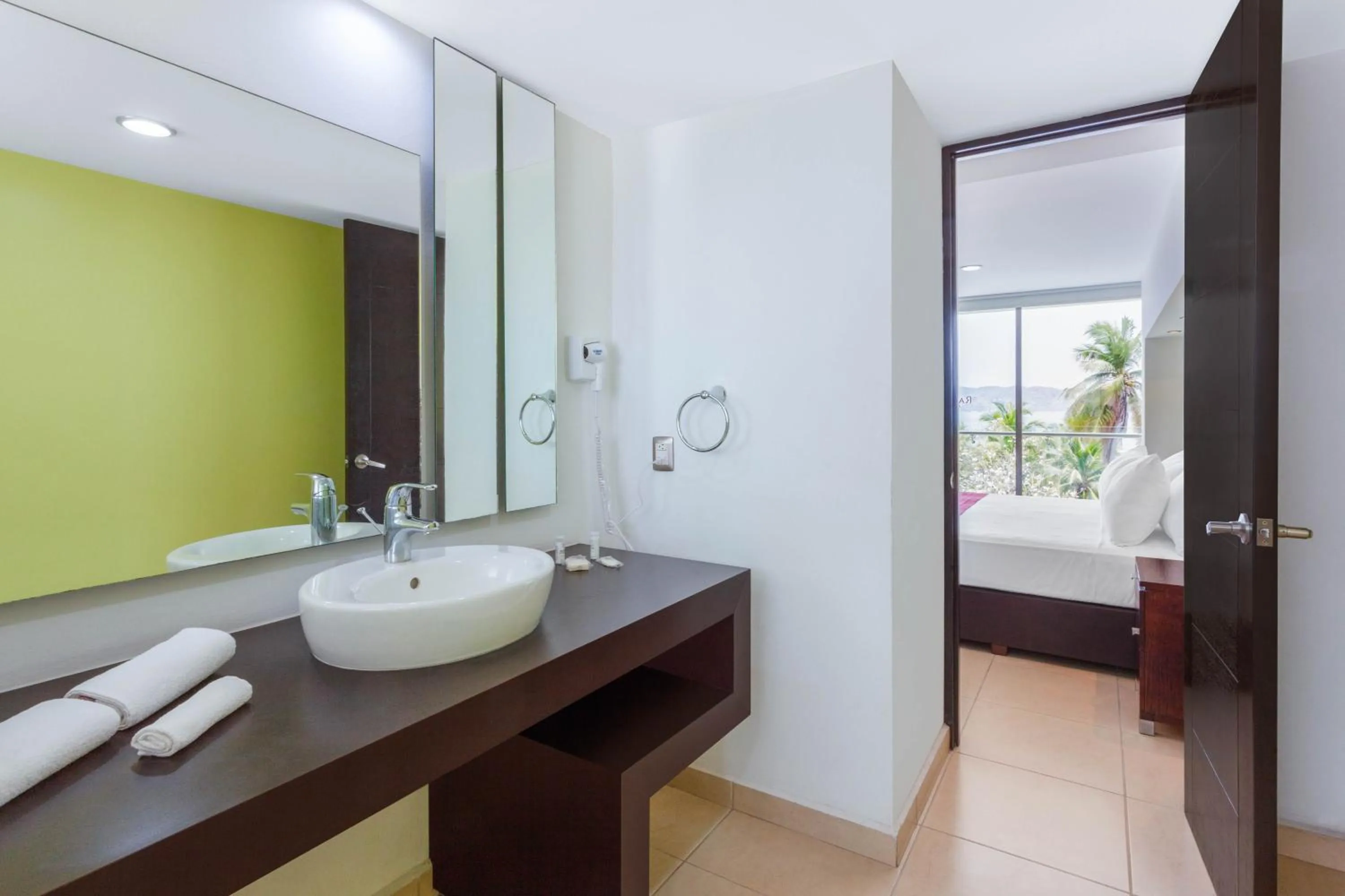 Bathroom, Bed in Ramada by Wyndham Acapulco Hotel & Suites