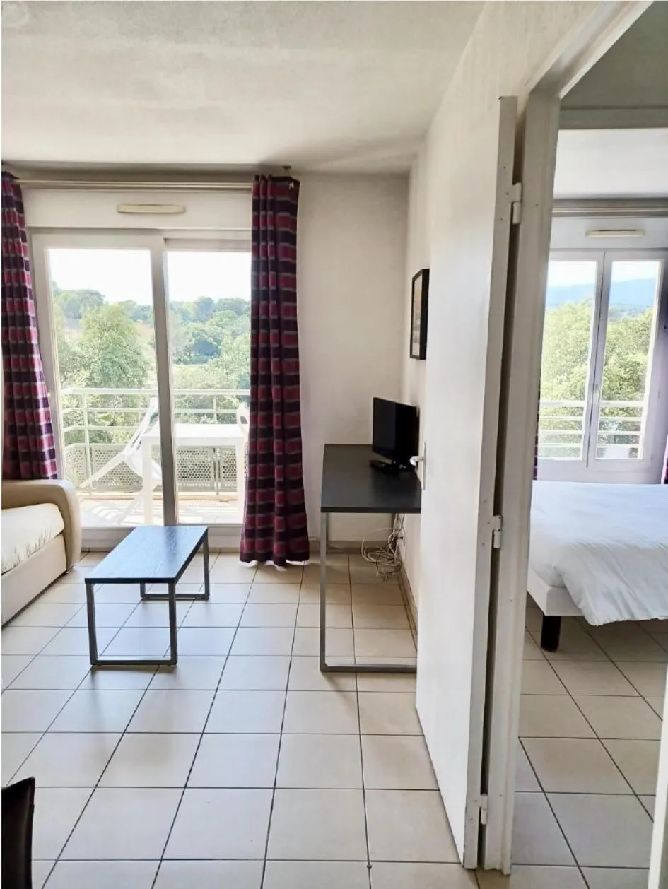 Seating area, Bed in Nemea Appart Hotel Green Side Biot Sophia Antipolis