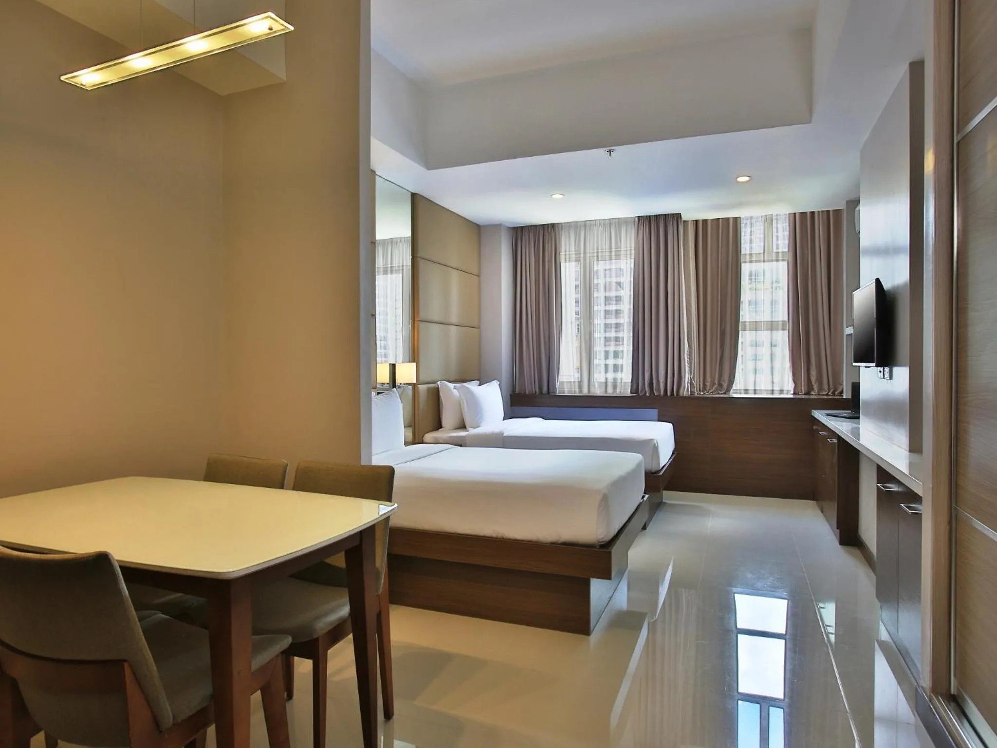 Bed in Valero Grand Suites by Swiss-Belhotel