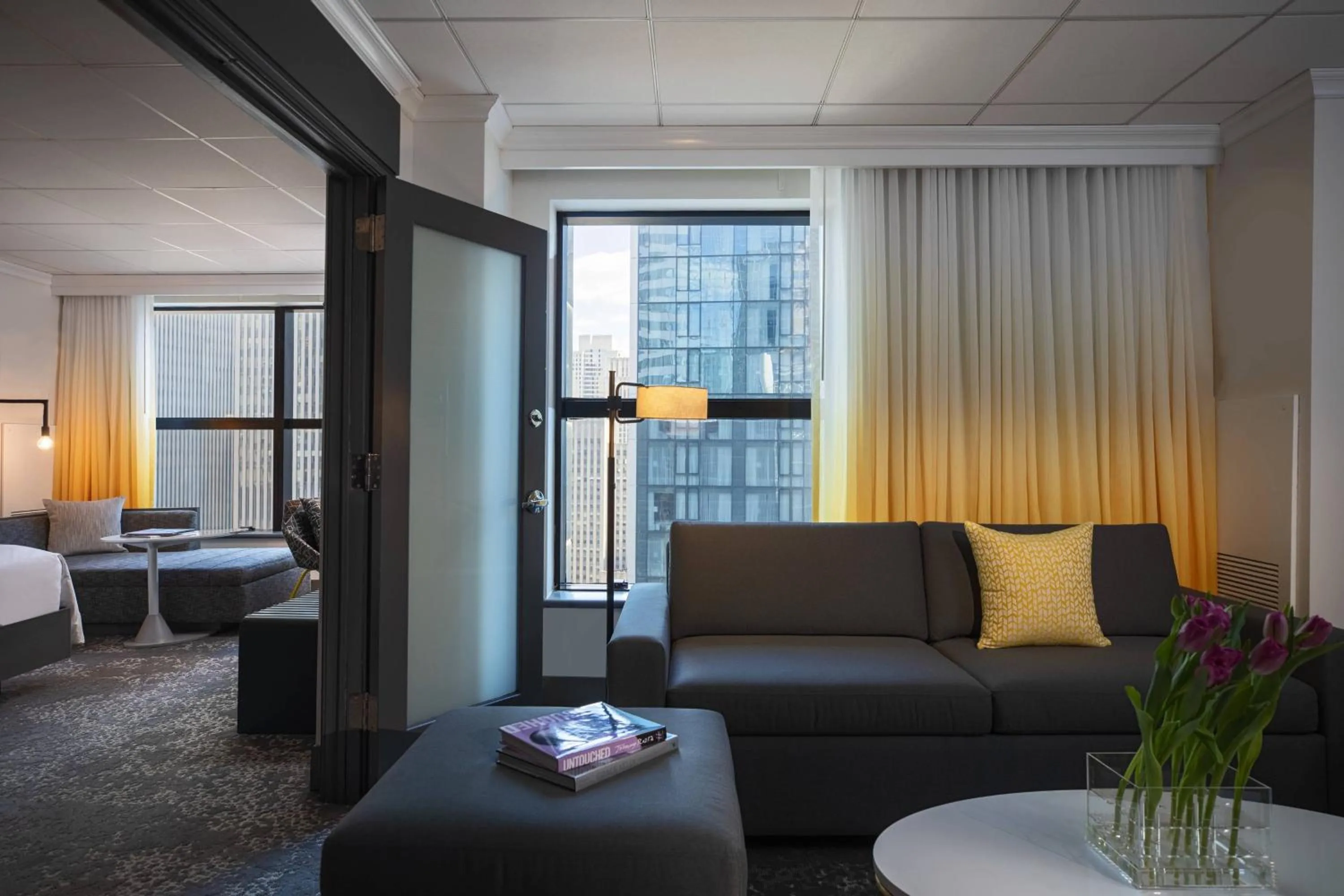 Living room, Bed in Renaissance New York Times Square by Marriott