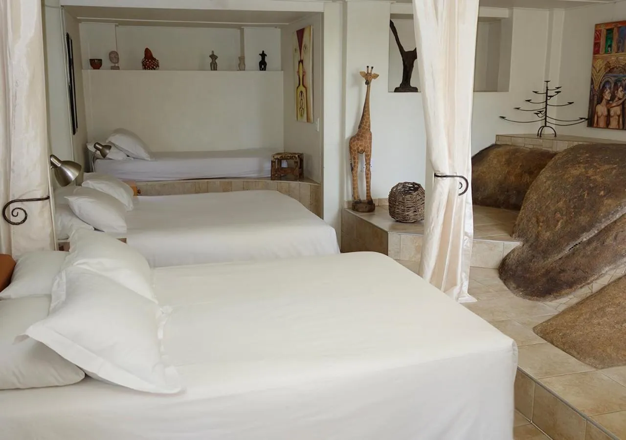 Bed in Veki's Village Cottages