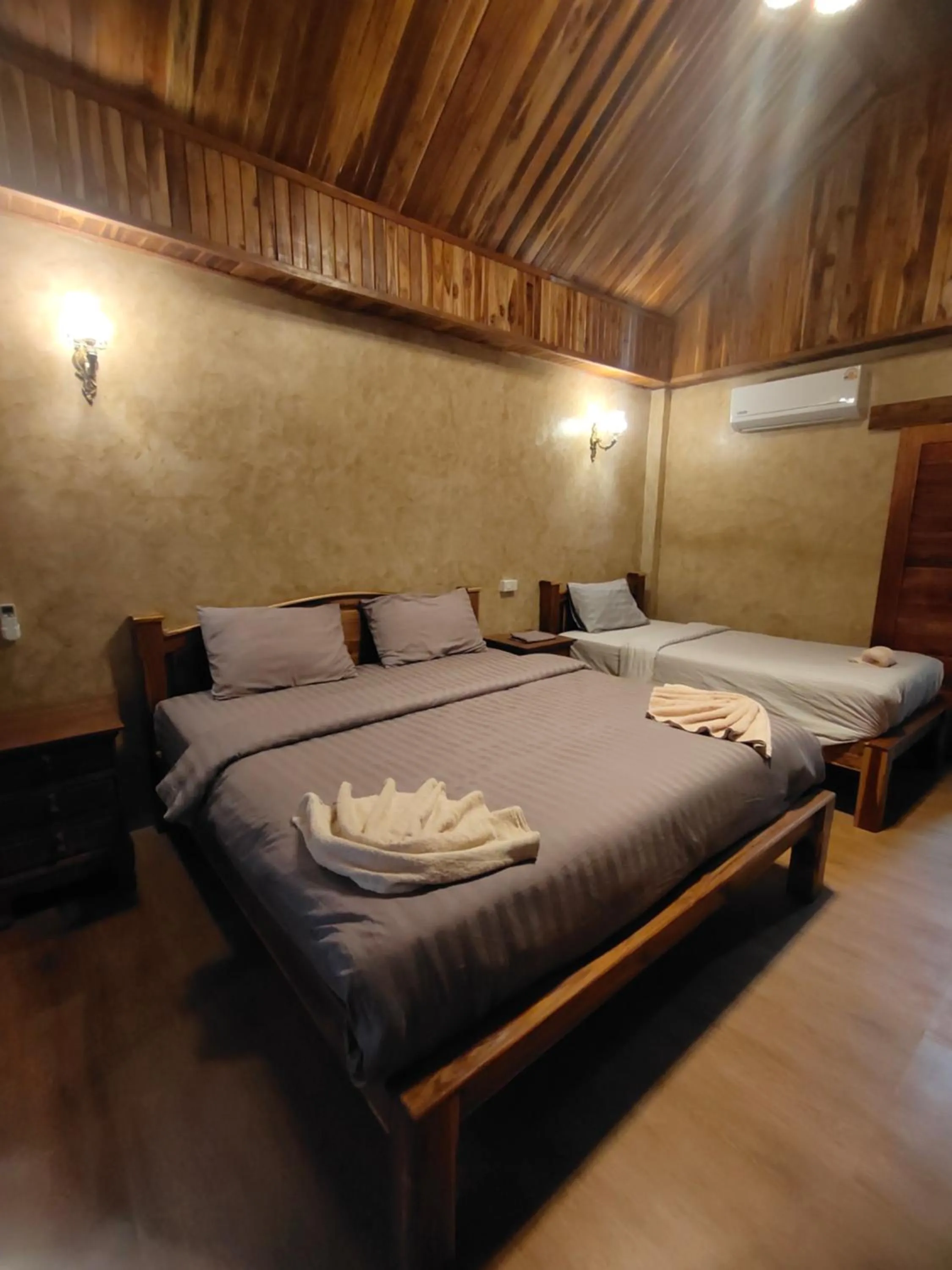 Bed in Phayam Coconut Beach Resort