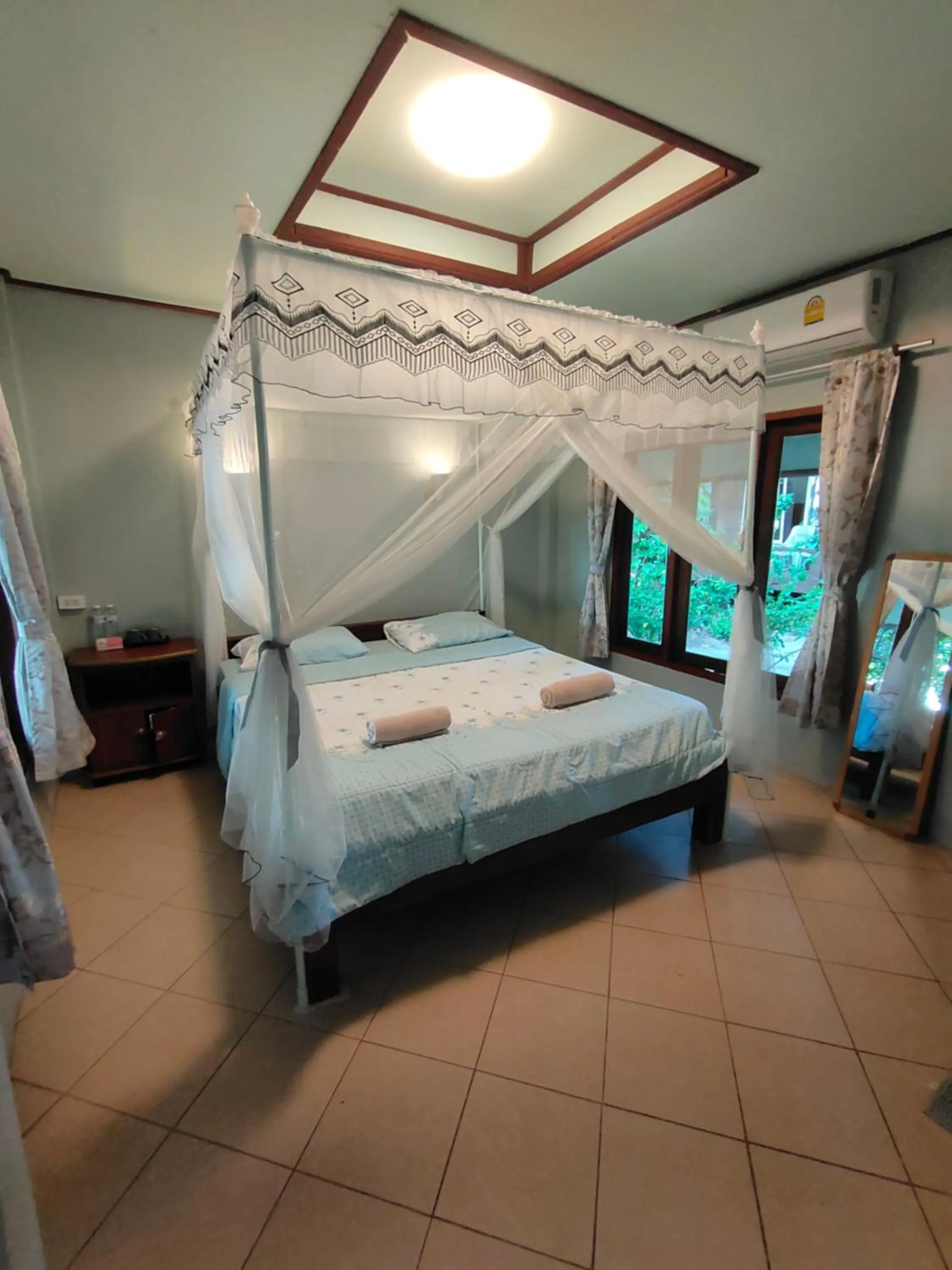 Bed in Phayam Coconut Beach Resort