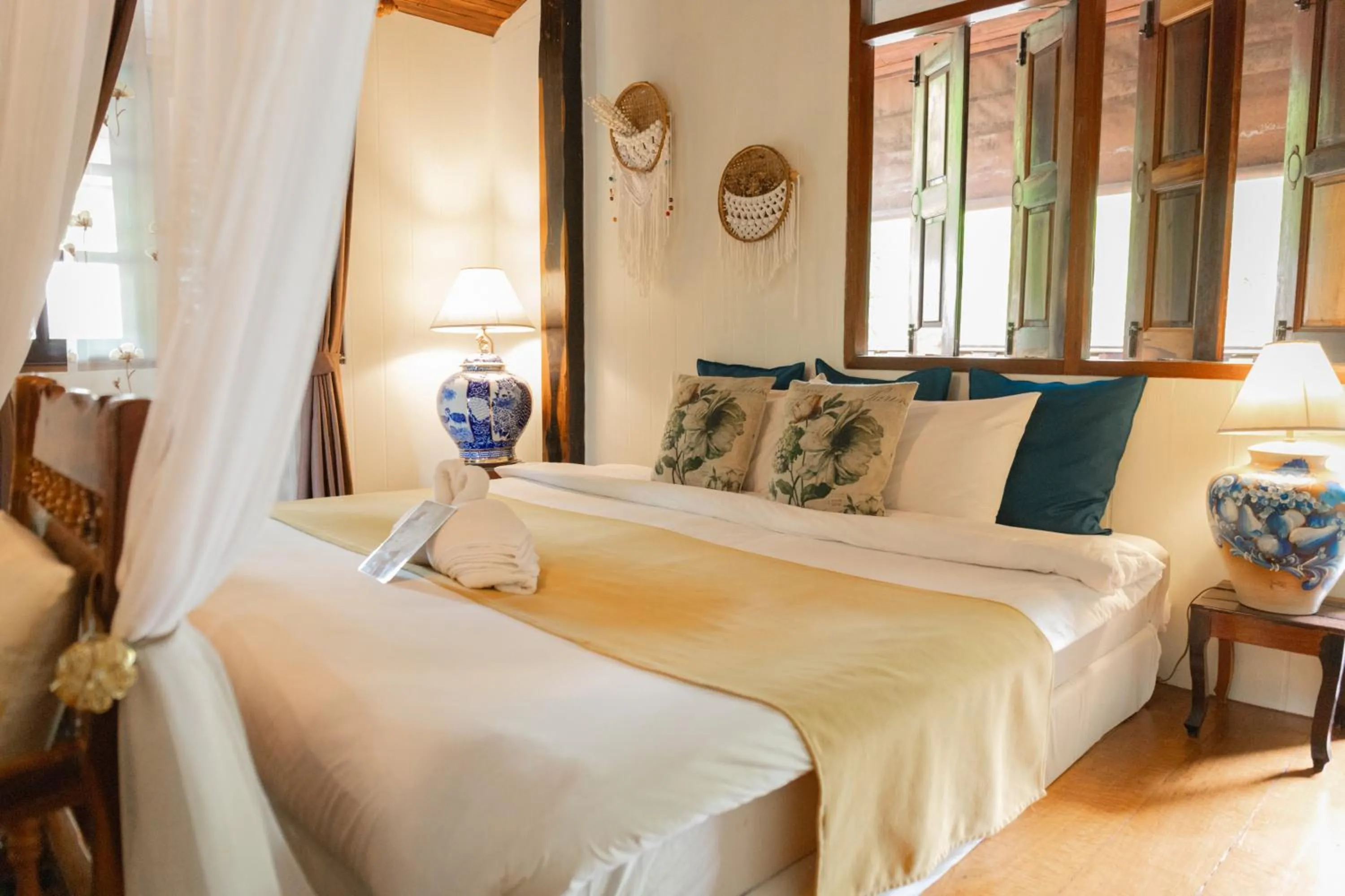 Bed in The Antique Riverside Resort