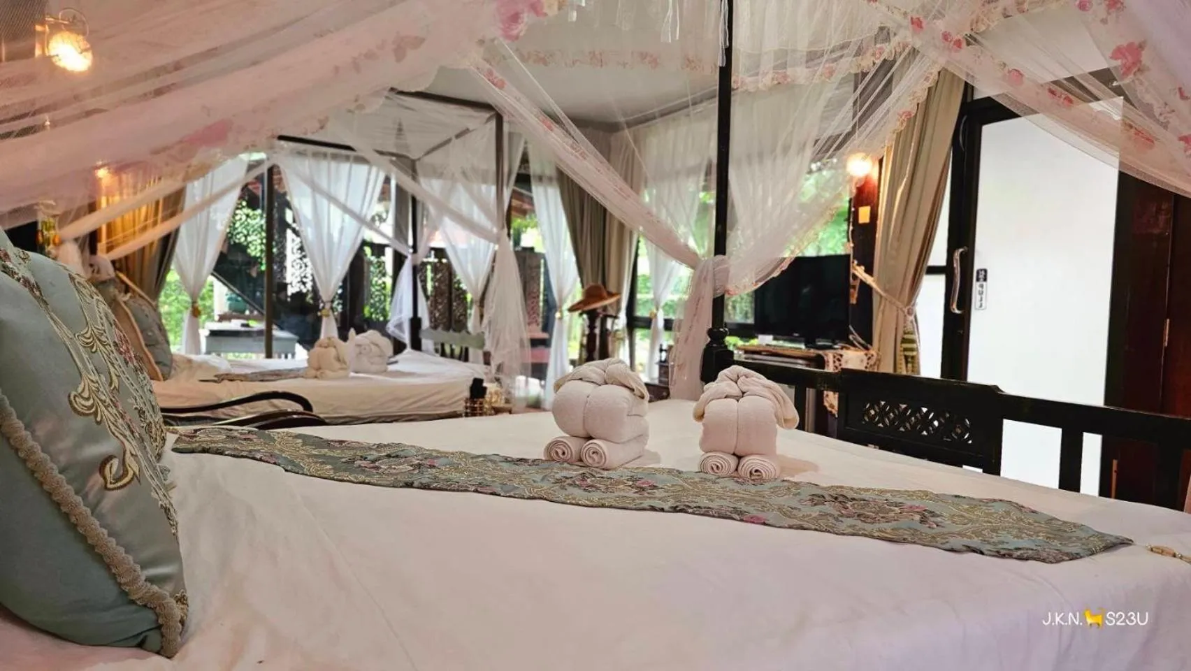 Bed in The Antique Riverside Resort