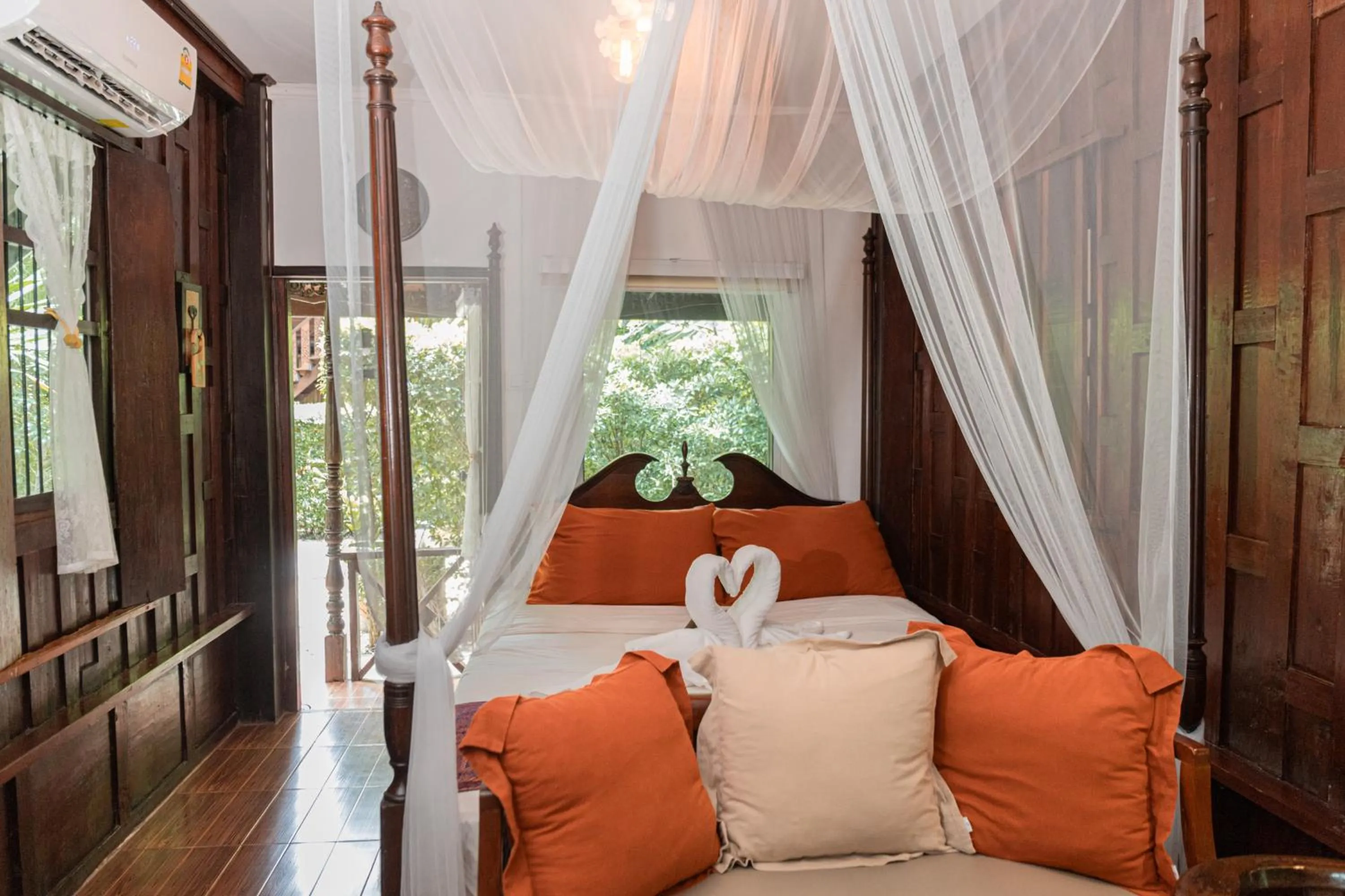 Bed in The Antique Riverside Resort