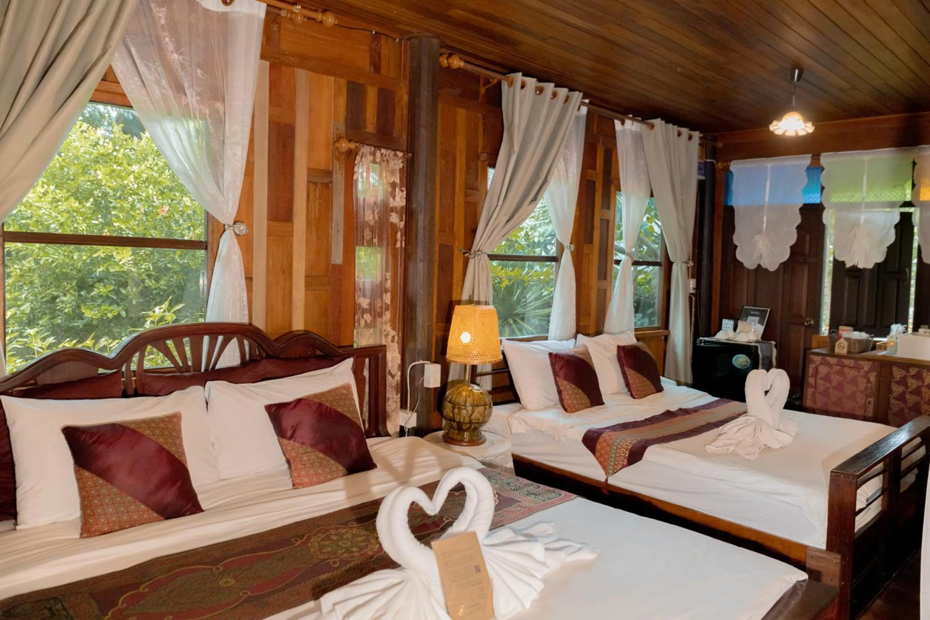 Bed in The Antique Riverside Resort