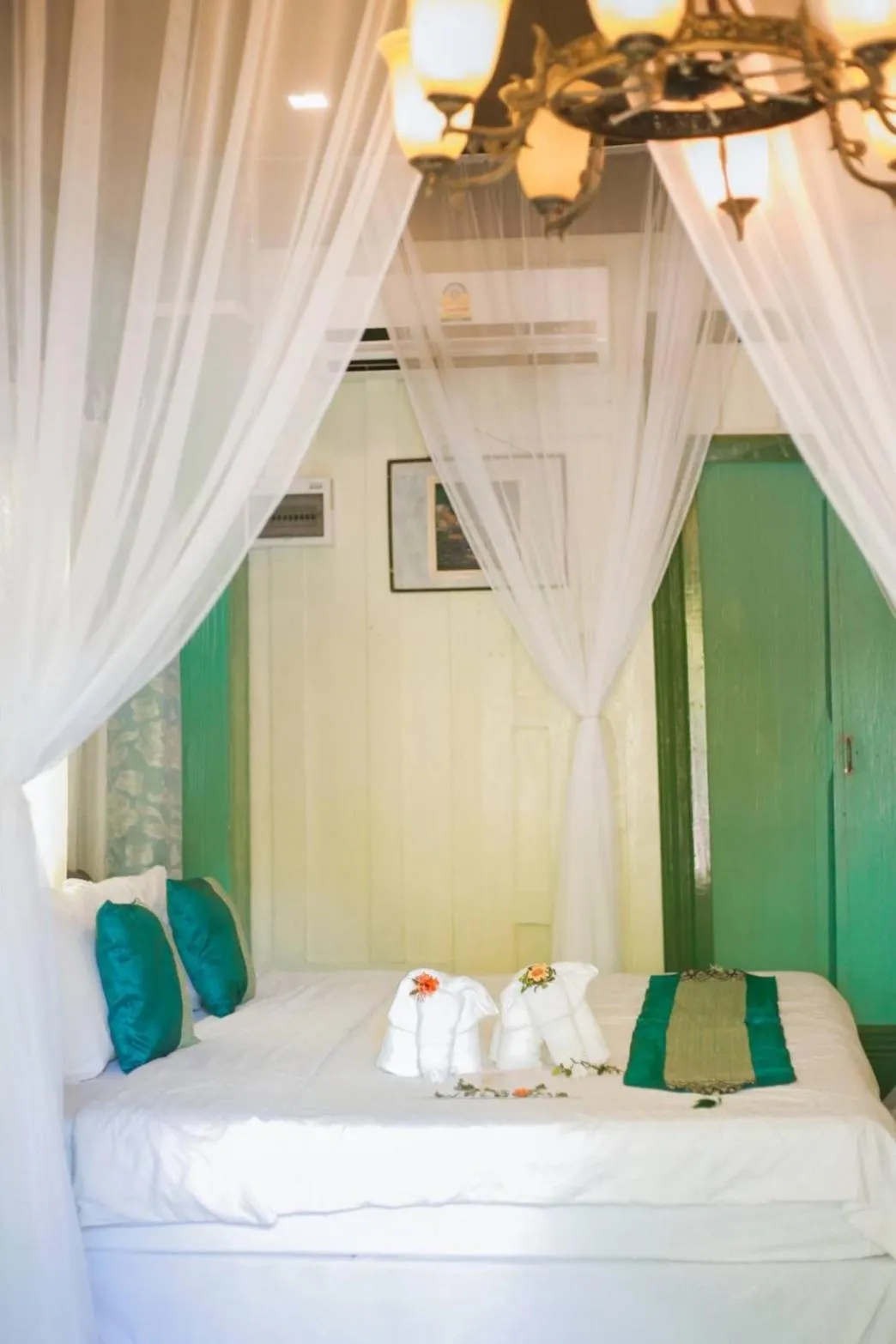 Bed in The Antique Riverside Resort