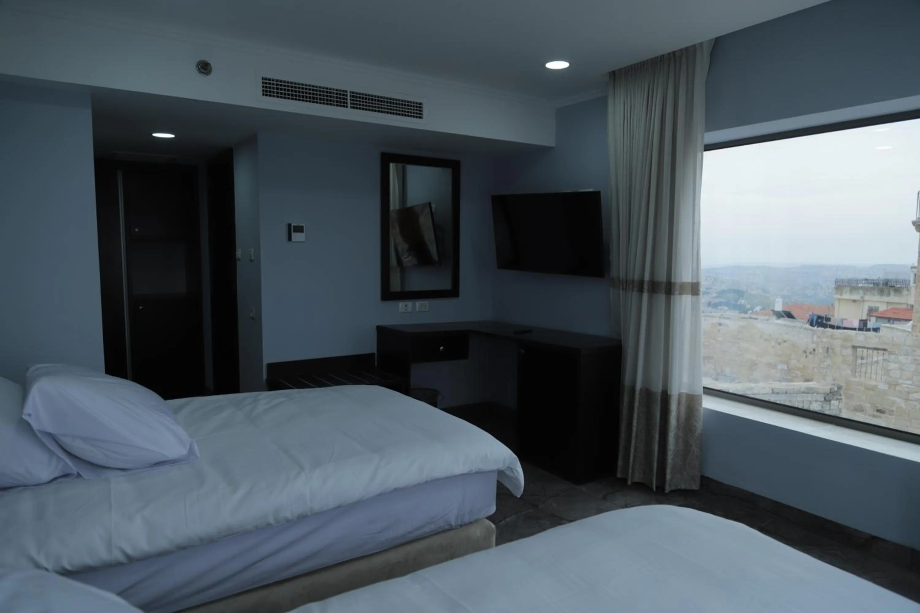 Communal lounge/ TV room, Bed in Mount of Olives Hotel