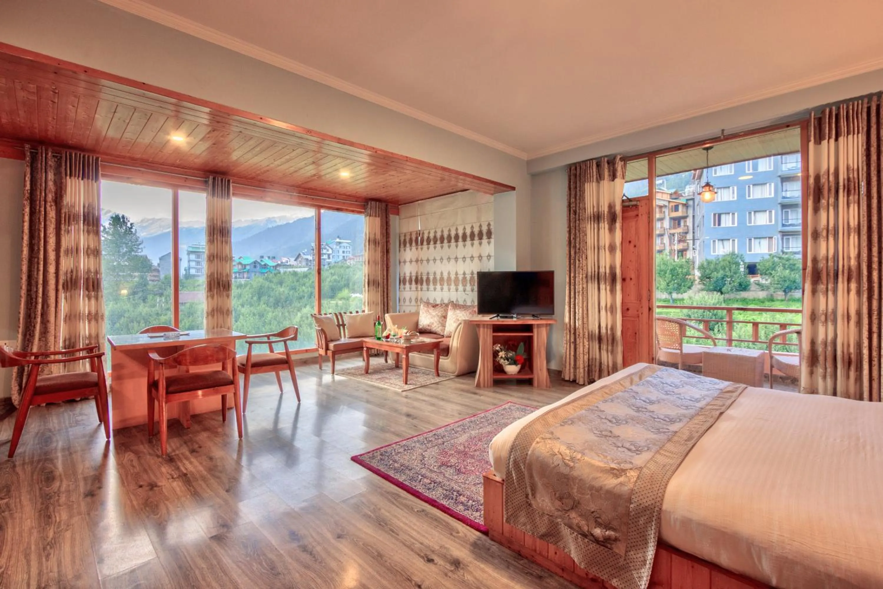 Seating area, Bed in Snow Flakes Resort And Spa Centrally Heated Luxury Resort