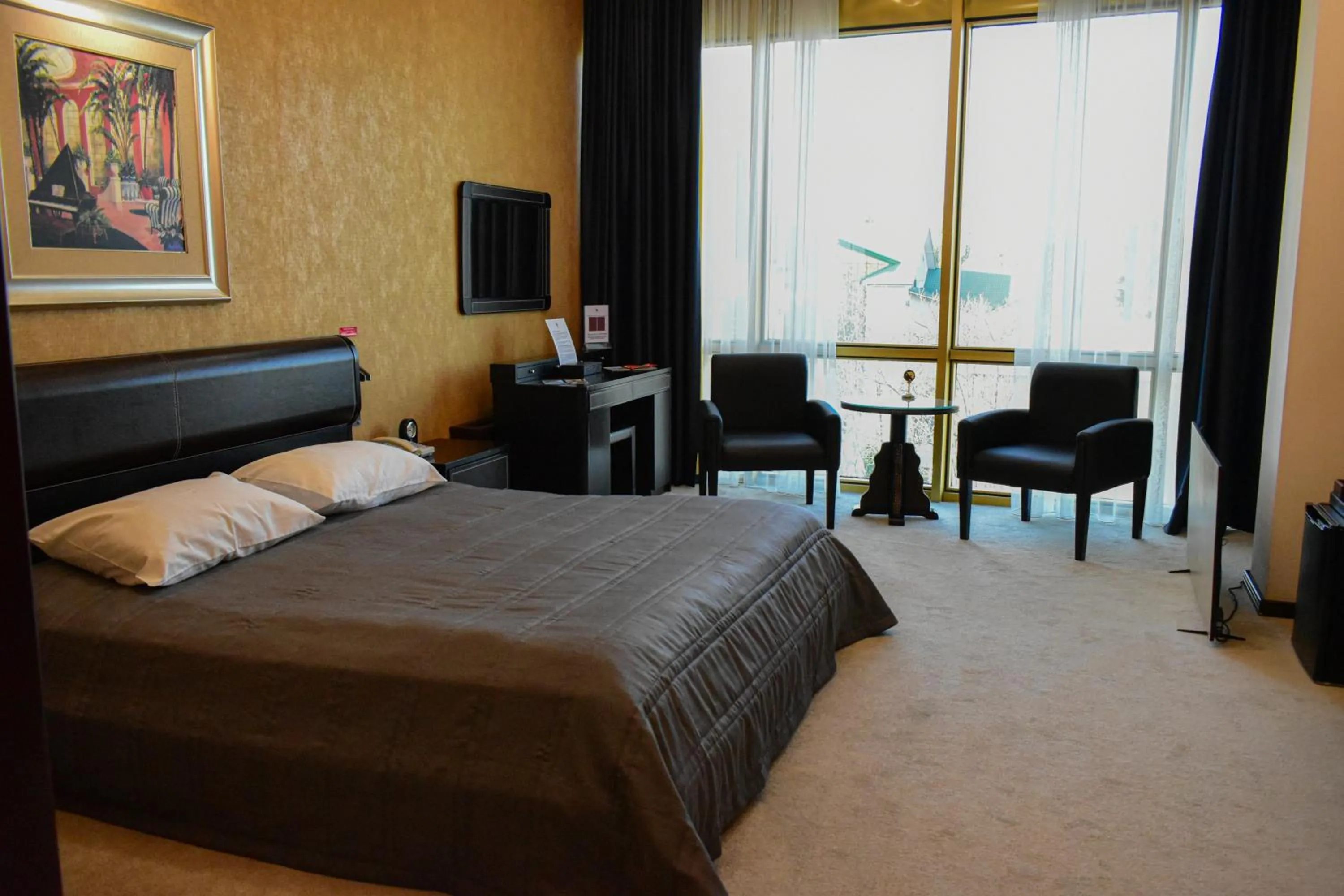 Communal lounge/ TV room, Bed in Hotel Feride