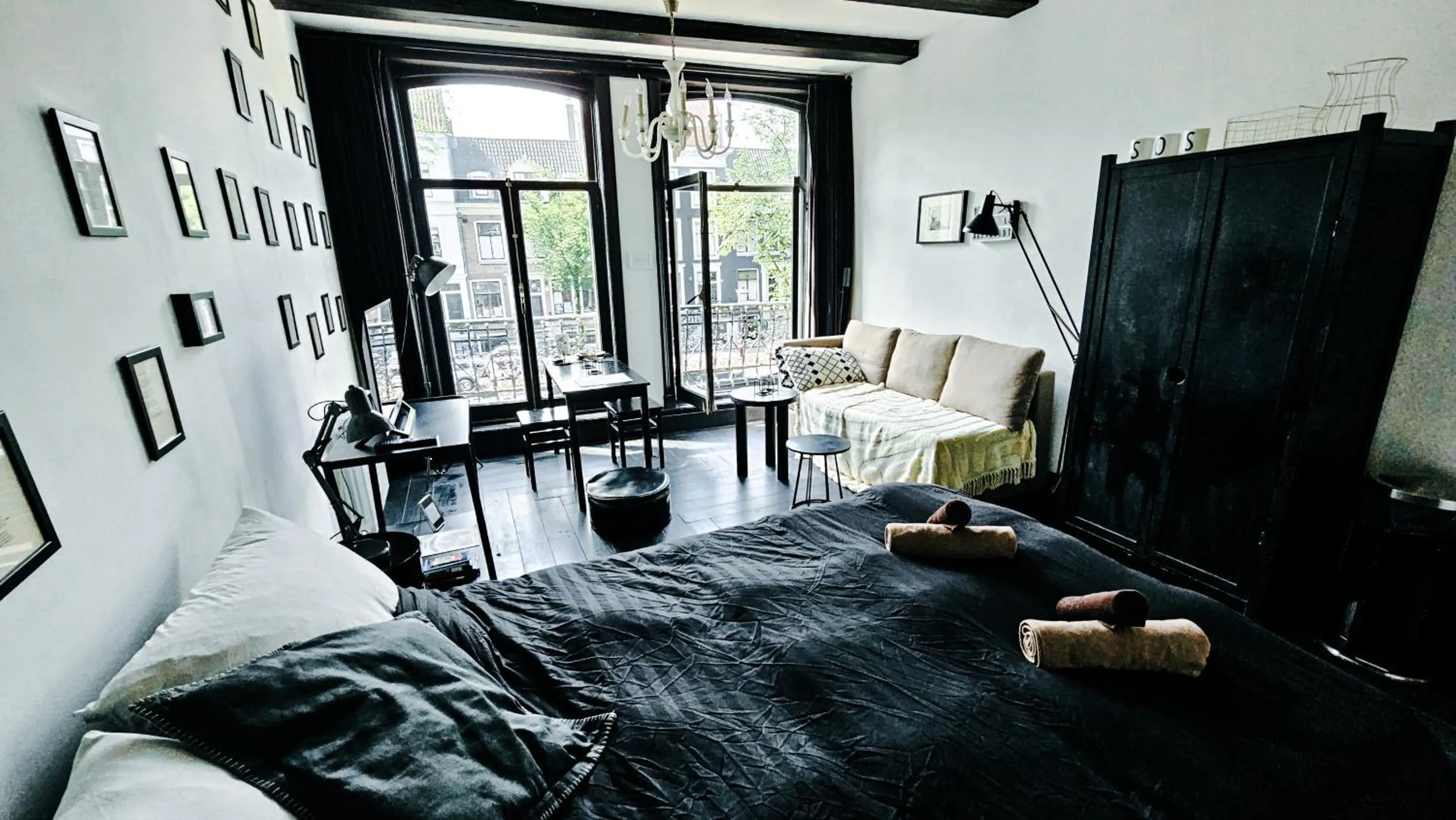 Bed in JoyJoyJoy the Black Beauty ecolicious studio in a canal house with French balcony with view on the canals