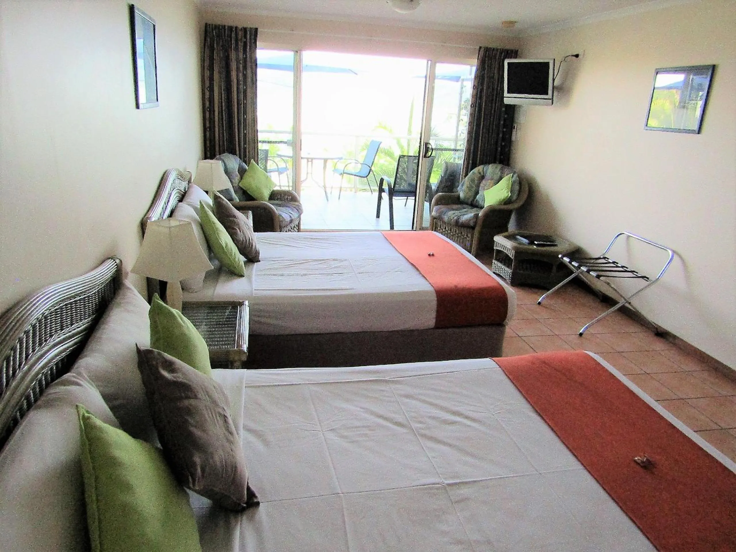 Bed in Sunlit Waters Studio Apartments