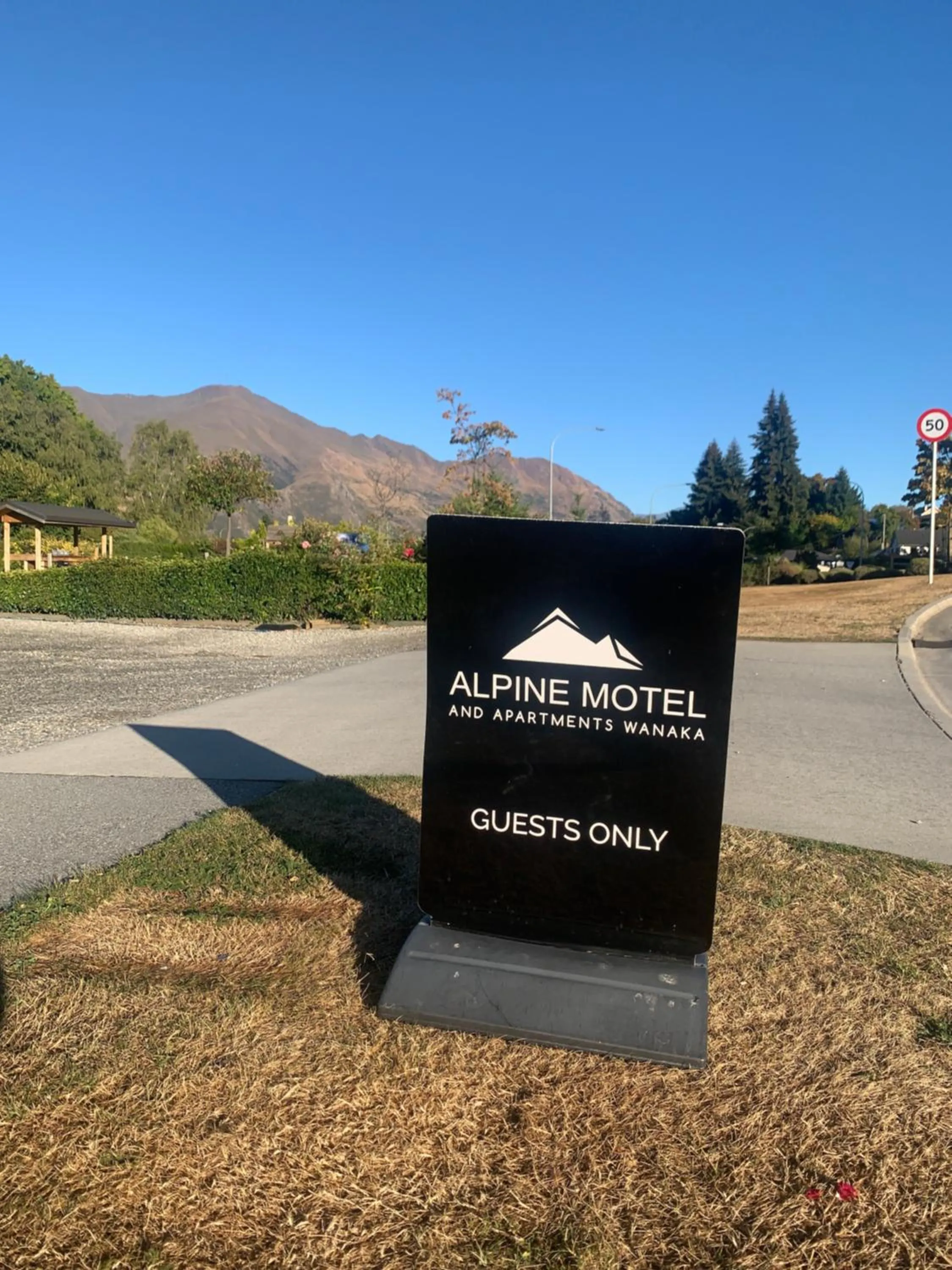 Property logo or sign in Alpine Motel