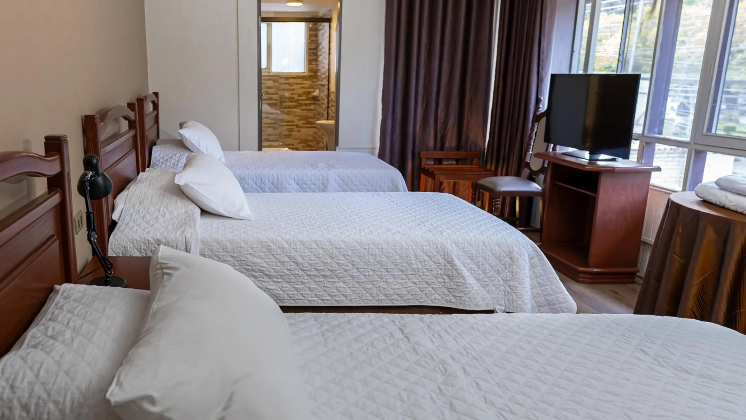 Bed in El Prado Hotel