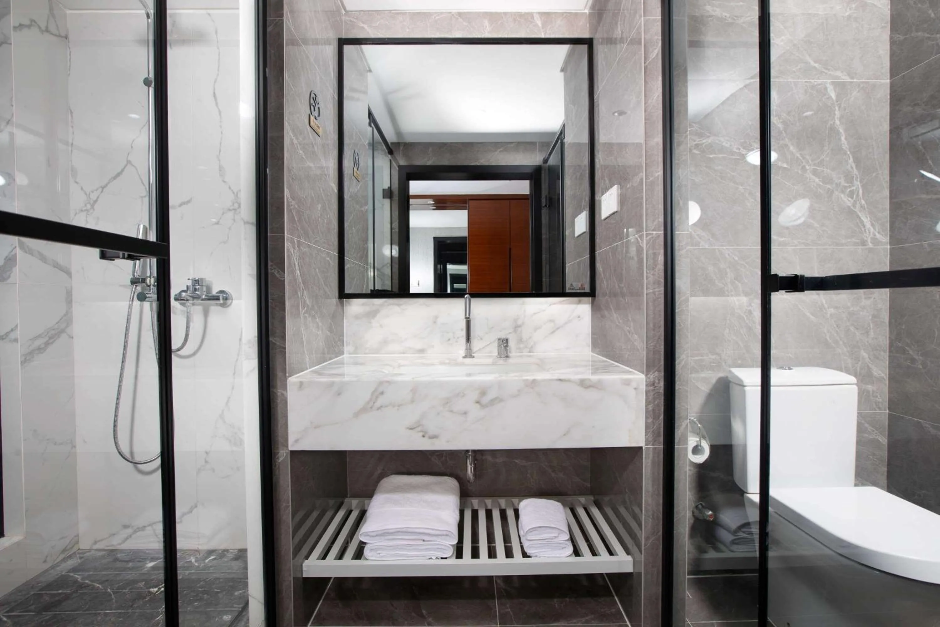 Bathroom in Ramada Encore by Wyndham Qionghai Downtown