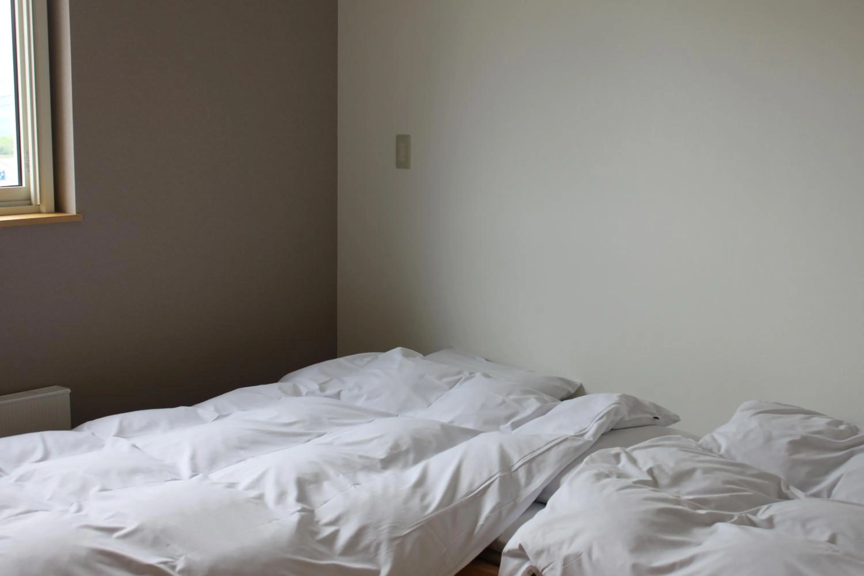 Bed in Niseko Guesthouse Nalu.