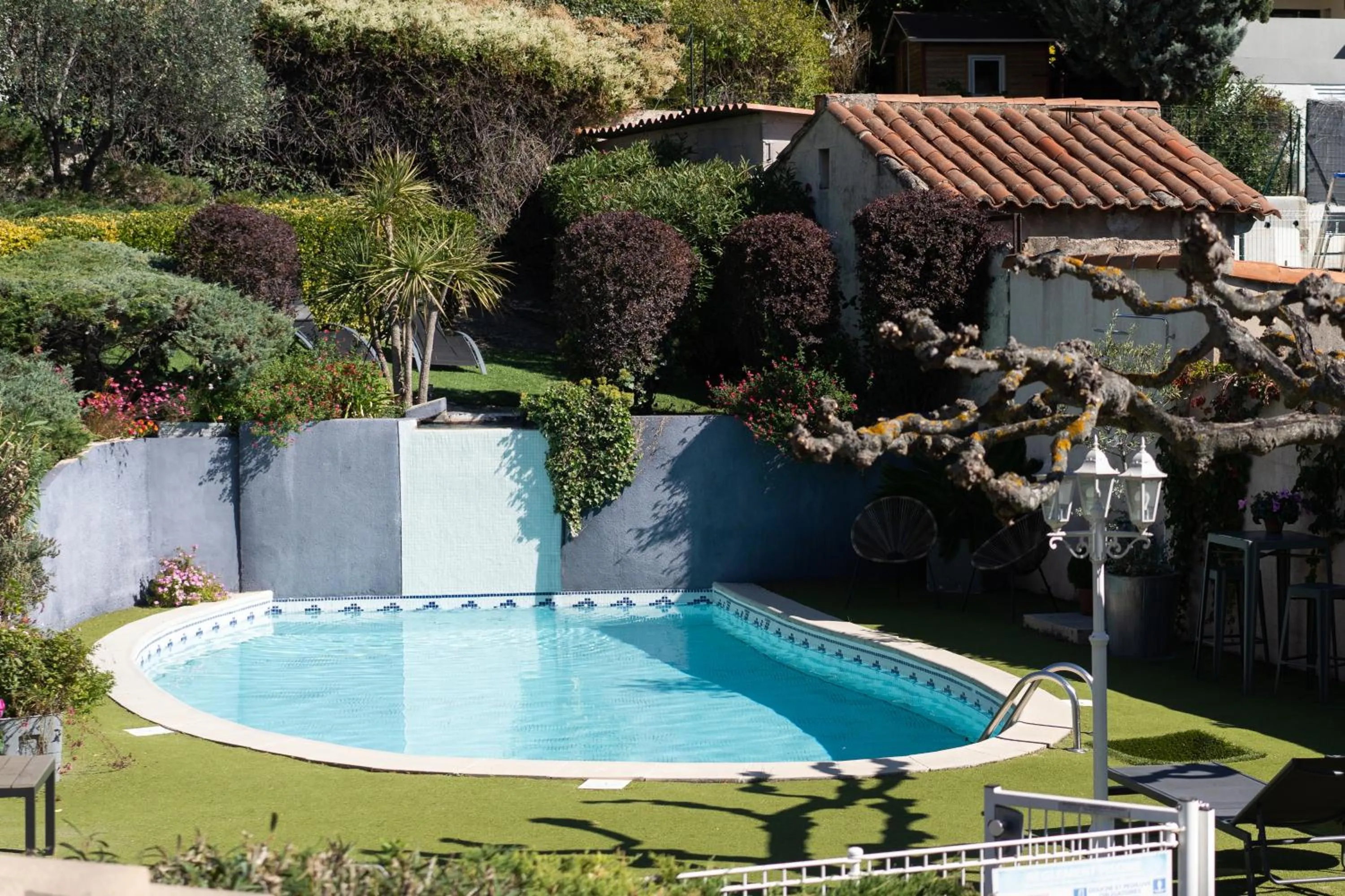 Garden view in Logis Hôtel La Fenière