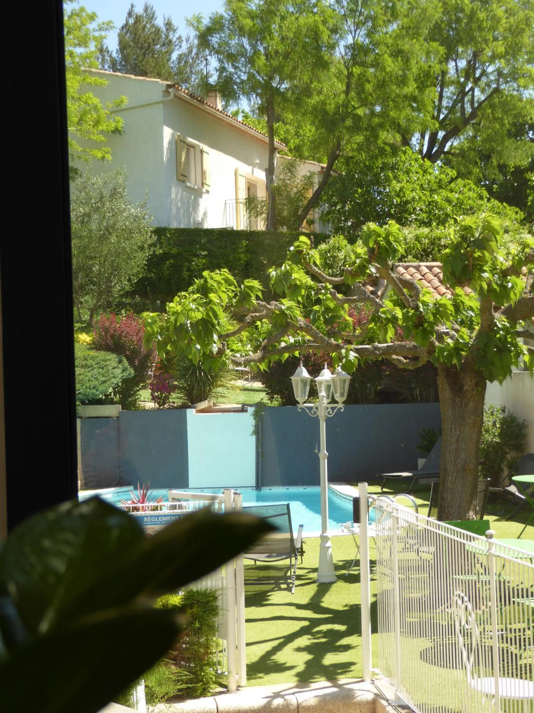 Garden view in Logis Hôtel La Fenière