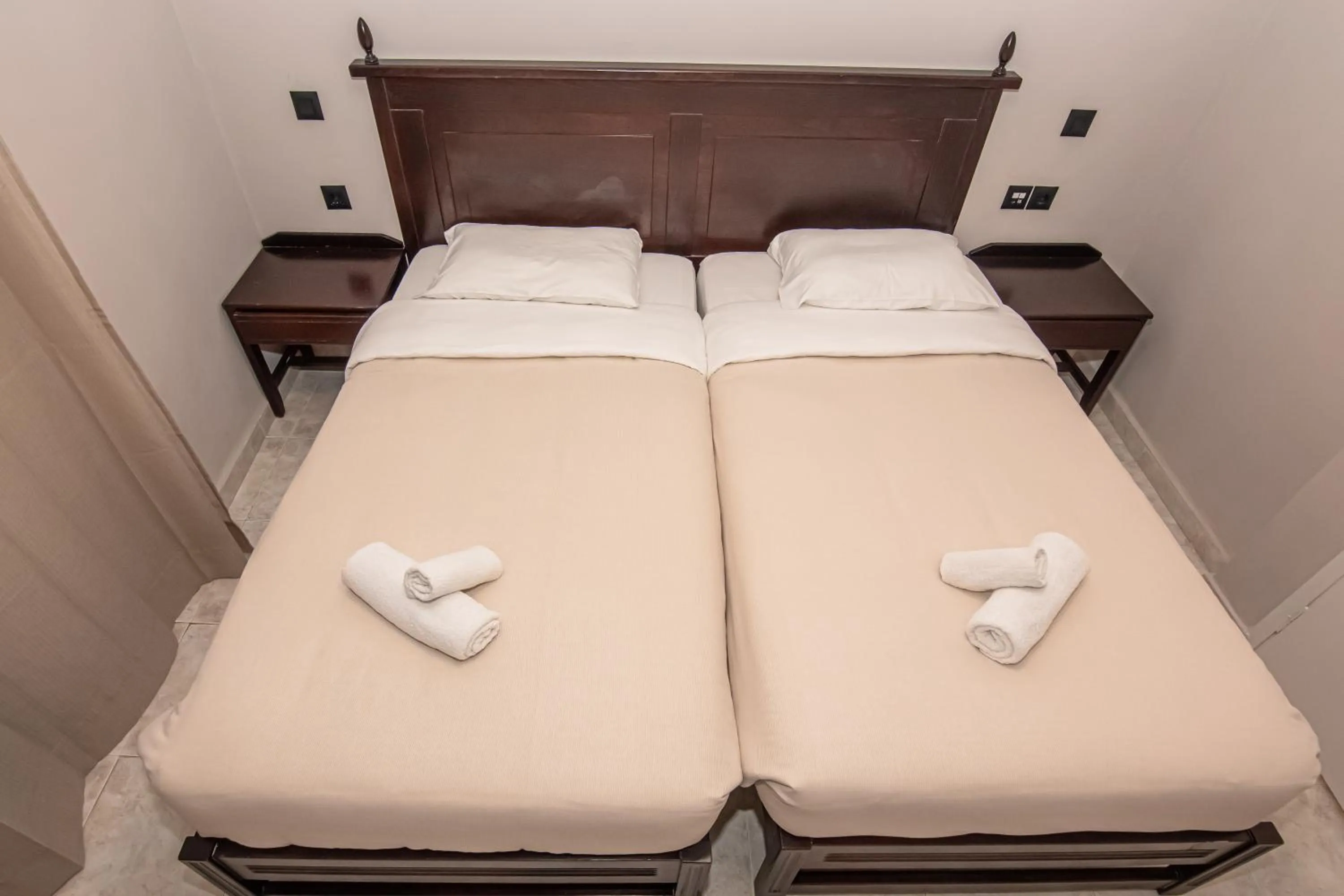 Bed in Talos Hotel Apartments