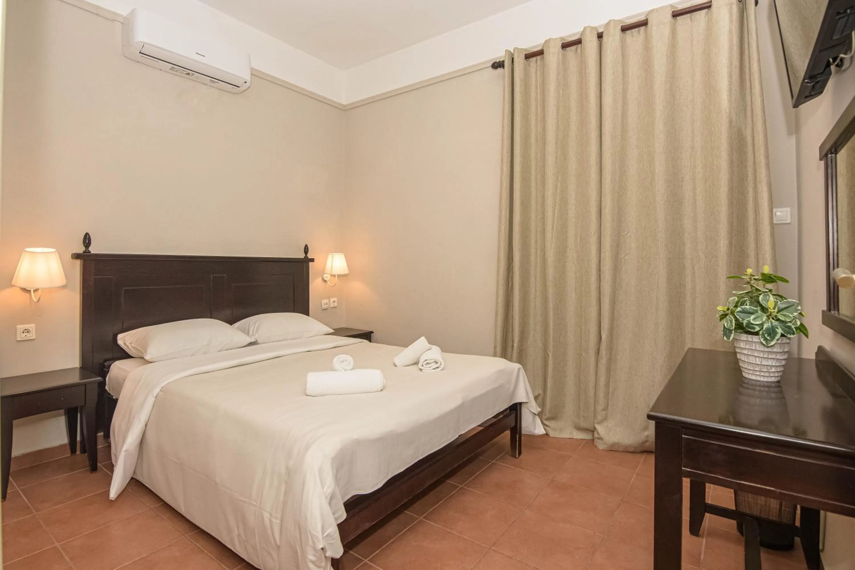 Bed in Talos Hotel Apartments