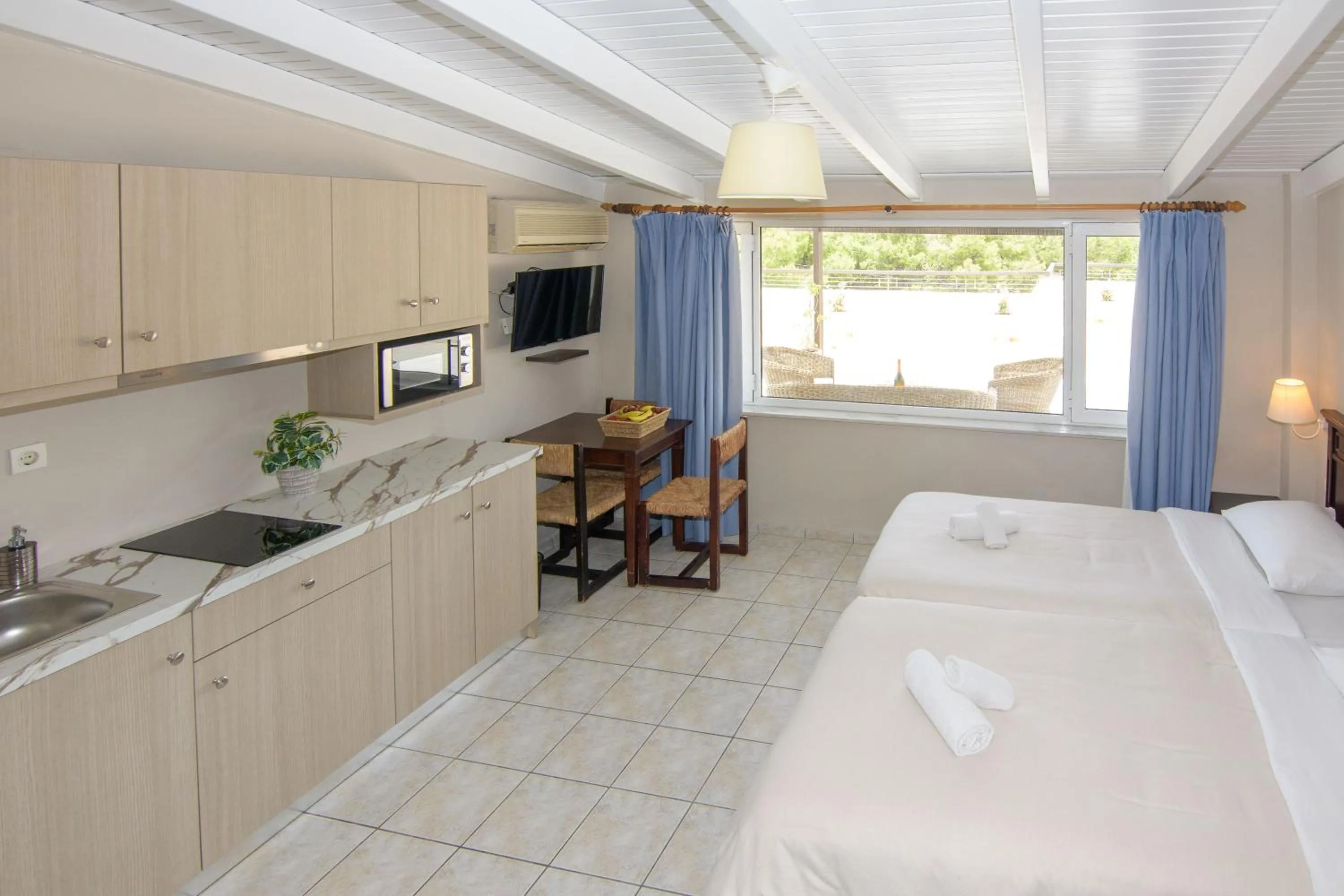 Bed in Talos Hotel Apartments