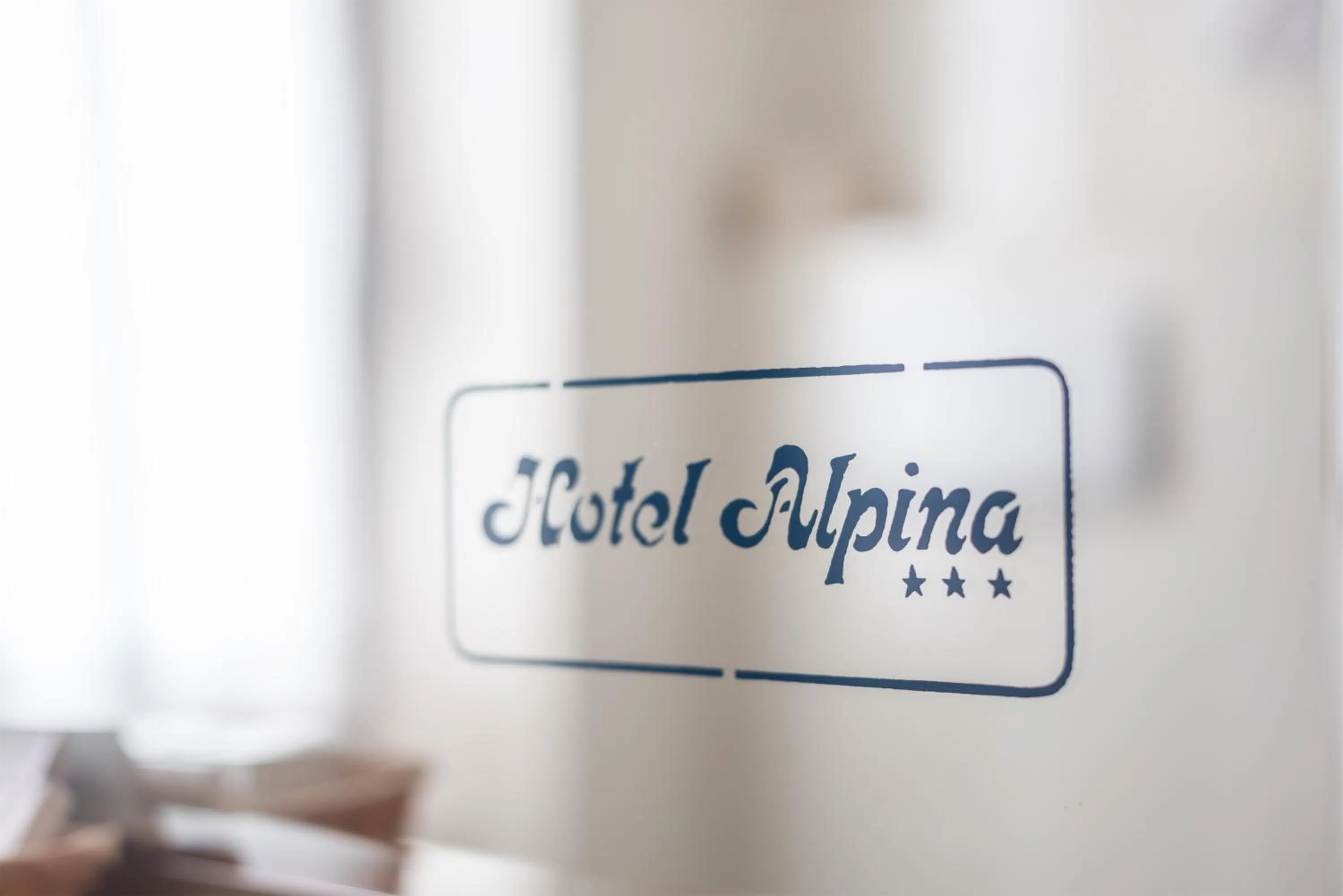 Property logo or sign in Hotel Alpina
