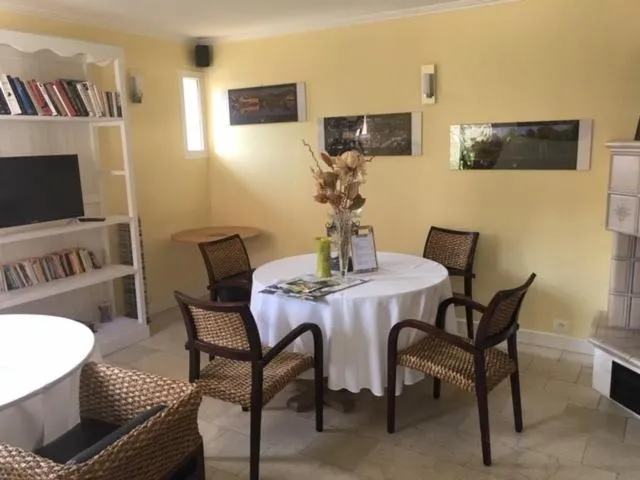 Communal lounge/ TV room in Logis Hotel Le Nuage