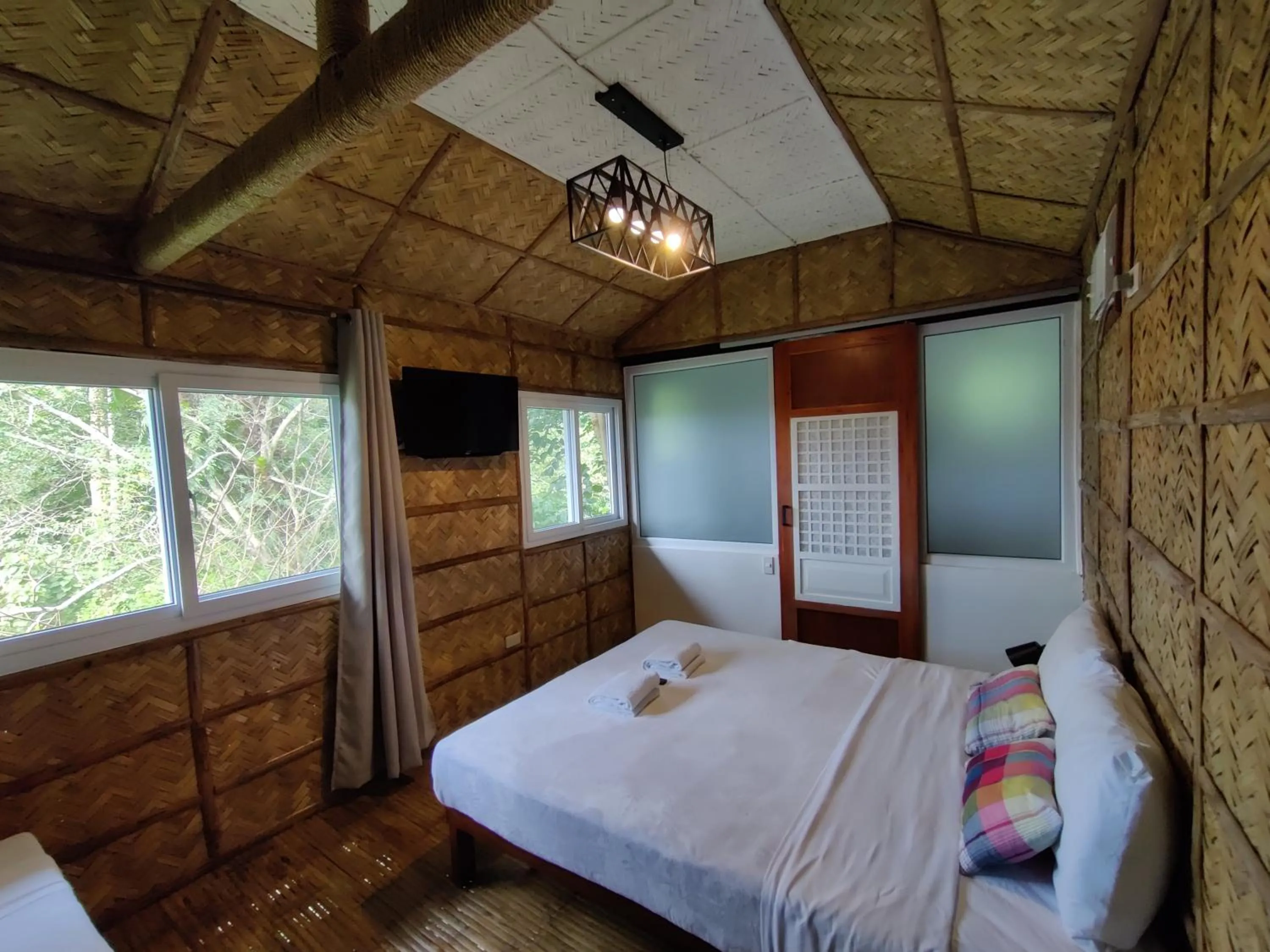 Bed in The Duyan House at Sinagtala Resort
