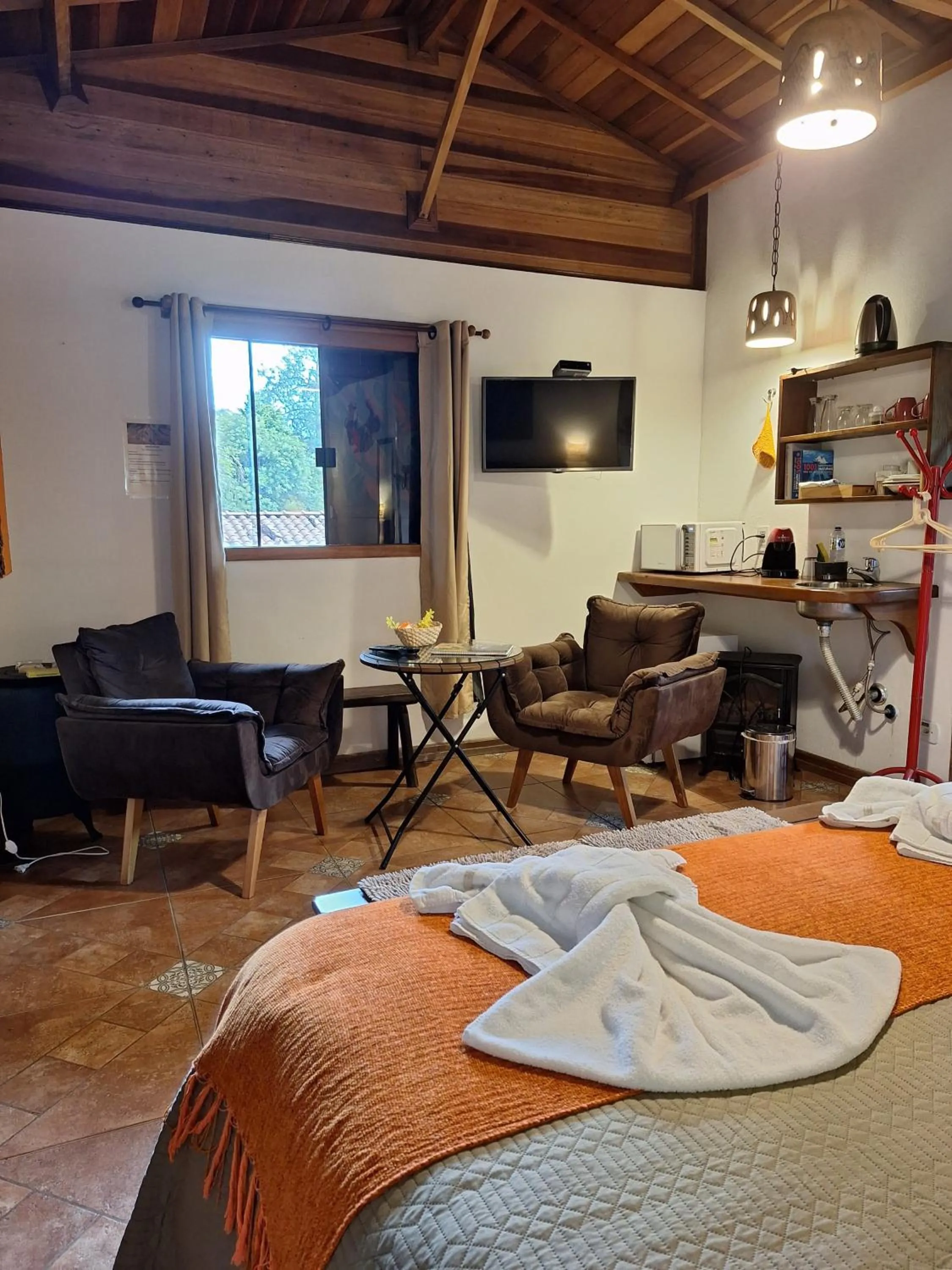 Seating area, Bed in Chalés ANECUEM