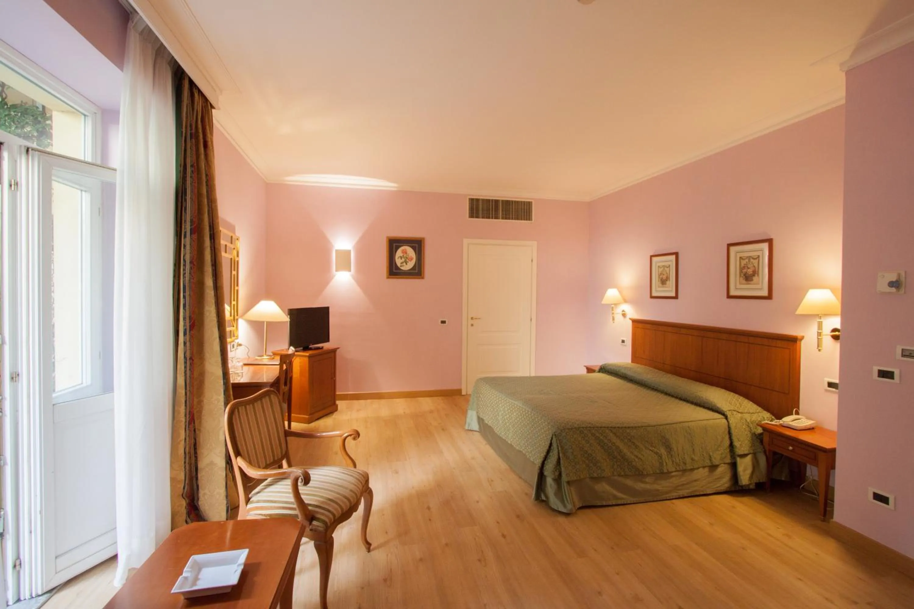 Photo of the whole room, Bed in Ateneo Garden Palace