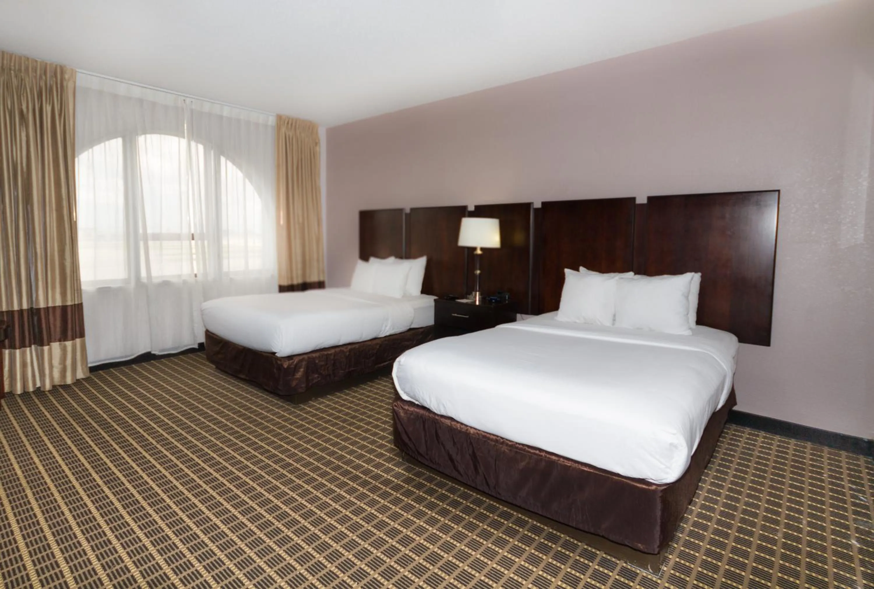 Bed in Clarion Inn & Suites Miami International Airport