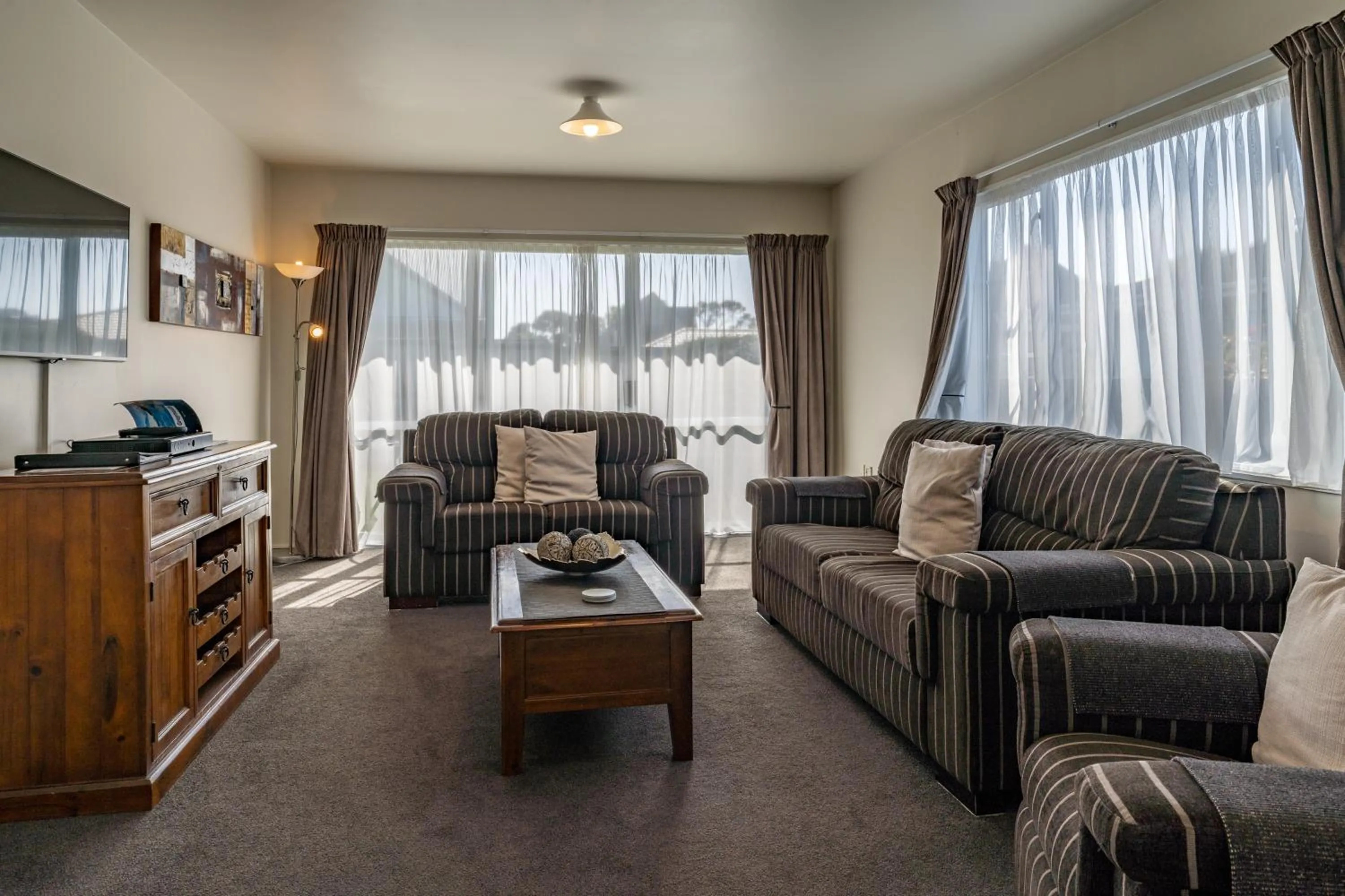 Seating area in ASURE Gables Motor Lodge