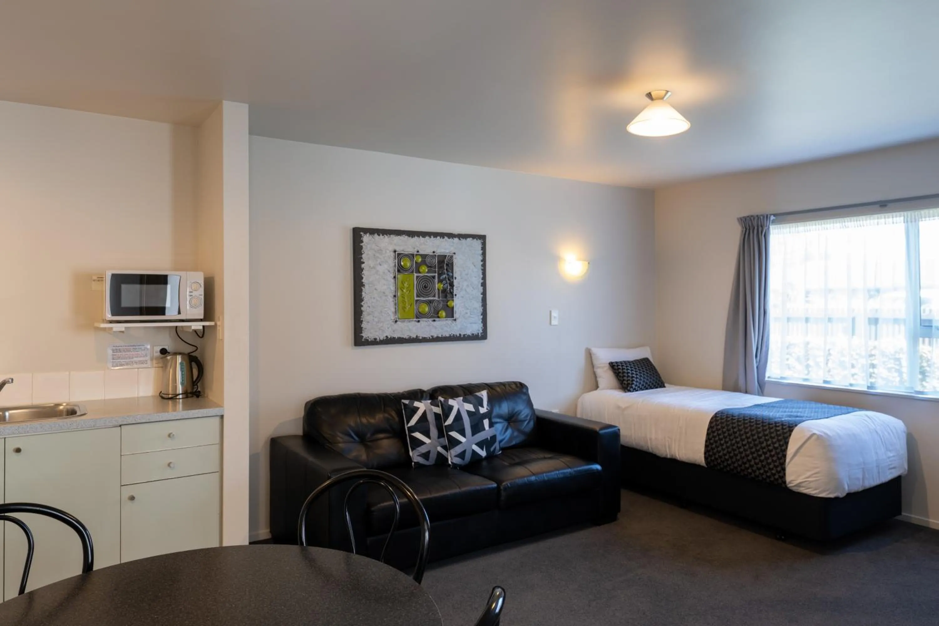 Bed in ASURE Gables Motor Lodge