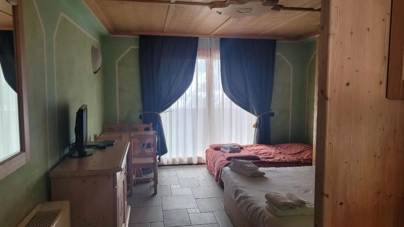 Bed in Boscone Suite Hotel