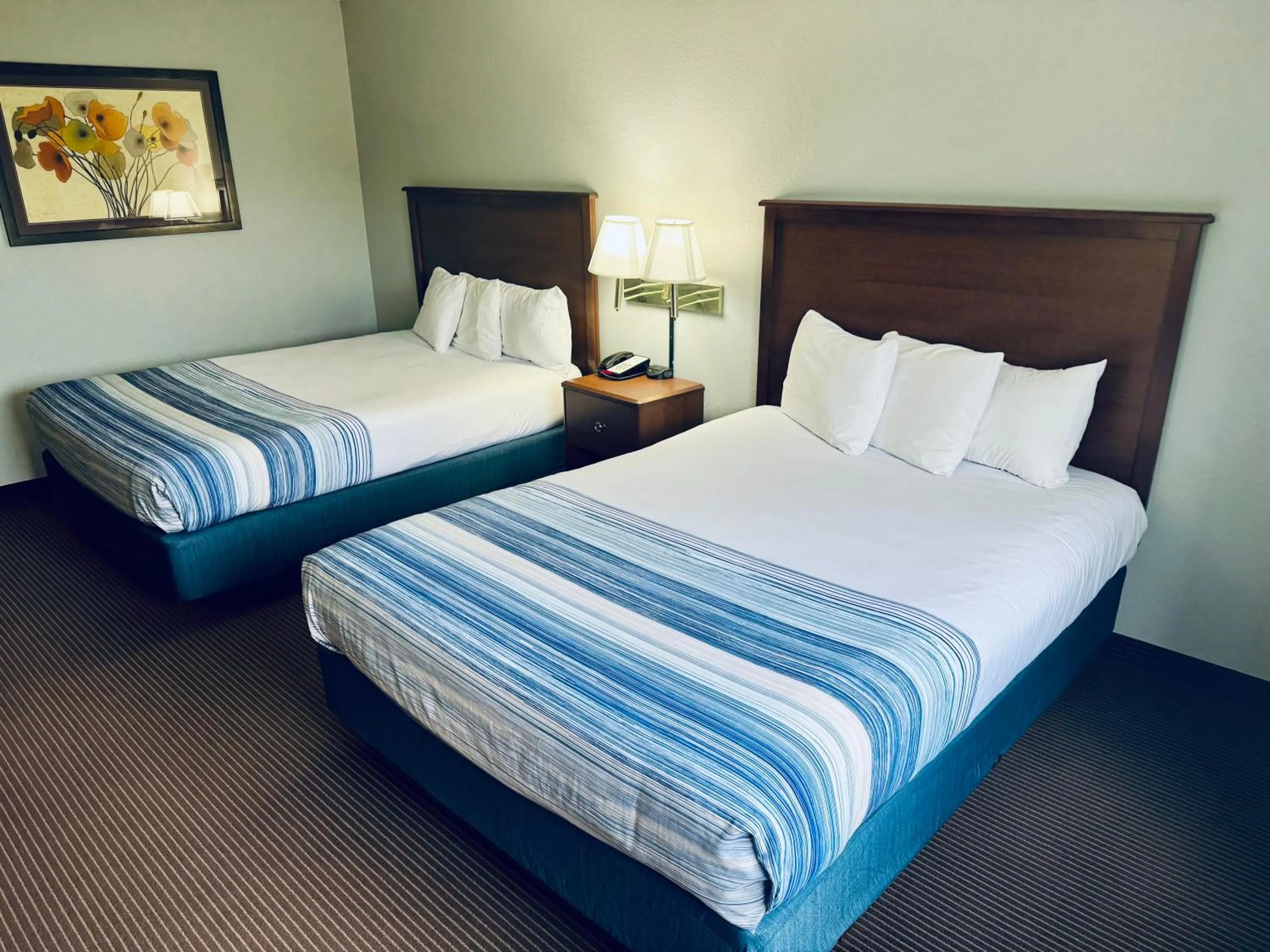 Bed in AmericInn by Wyndham Stillwater