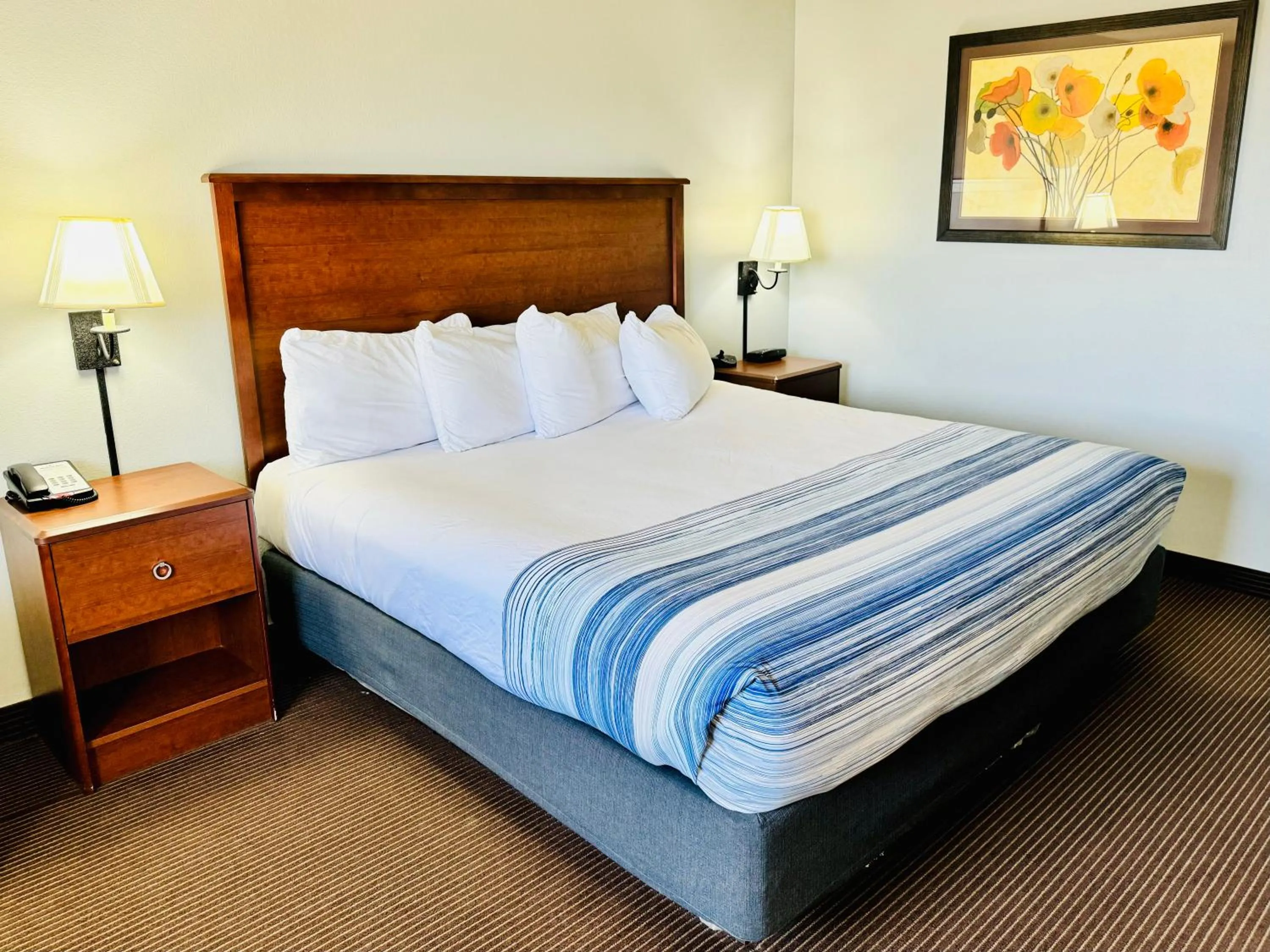 Bed in AmericInn by Wyndham Stillwater